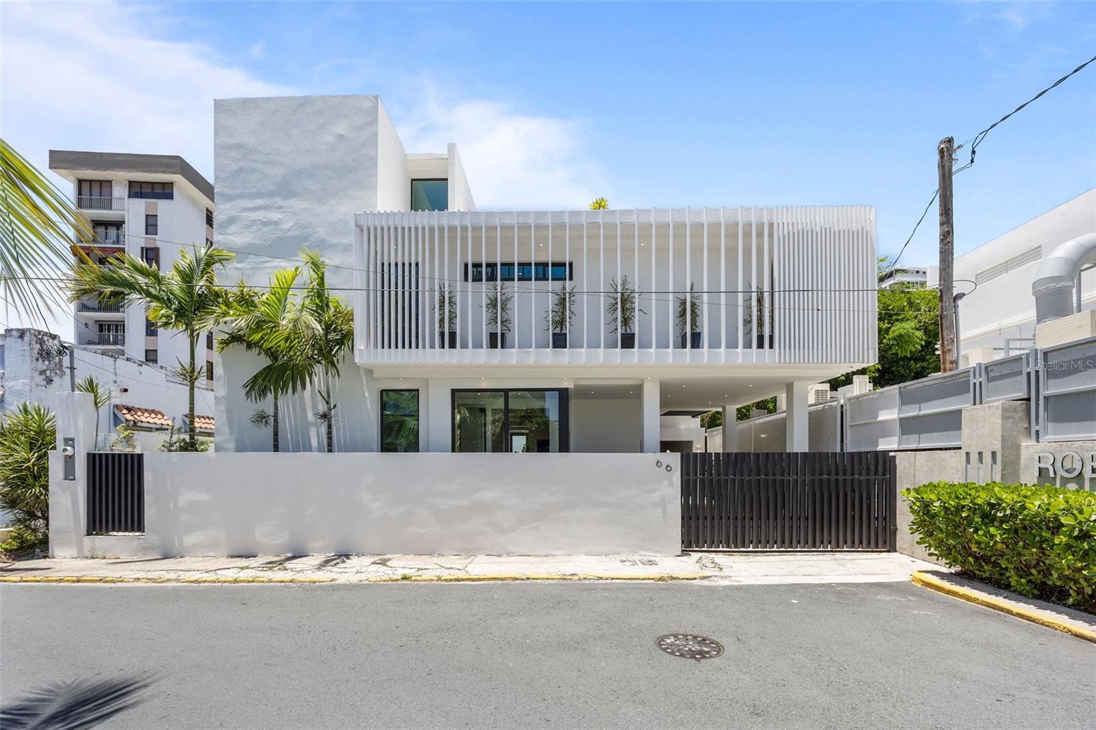 Situated in the coveted Condado neighborhood of San Juan, this fully renovated single-family home blends high-quality construction with modern design in a truly turnkey offering. Rebuilt in 2024 from the ground up, the residence spans approximately 4,000 square feet on a 5,000 square foot lot and features four spacious bedrooms, an office or convertible fifth bedroom, five full bathrooms, plus a half bath and an exterior bathroom and two outdoor showers that seamlessly connect indoor and outdoor living.

The thoughtfully planned layout supports both everyday comfort and effortless entertaining. Each bedroom offers generous proportions, custom Italian closet systems, and direct access to private louvered patios that invite natural light and cross-ventilation while maintaining privacy. Electric shades throughout the home add convenience and a cohesive, contemporary aesthetic.

At the heart of the property, the newly designed kitchen is outfitted with brand-new KitchenAid appliances, including a dishwasher, and is tailored for modern living with sleek finishes and efficient workflow. The pool area serves as a central gathering space, ideal for relaxing or hosting, while essential infrastructure upgrades such as a water cistern and full backup generator provide reliability and peace of mind.

A private rooftop patio expands the usable living space and is perfect for open-air dining and entertaining. This elevated retreat includes a built-in cement dining table, sink, and wine fridge, creating a functional outdoor kitchen and lounge environment.

Located near St. John's School, Robinson School, and Condado's renowned dining, shopping, beaches, and entertainment, the home offers exceptional convenience in one of Puerto Rico's most established urban neighborhoods. Sold fully furnished and move-in ready, this property delivers a rare combination of style, comfort, and long-term value in Condado real estate.
