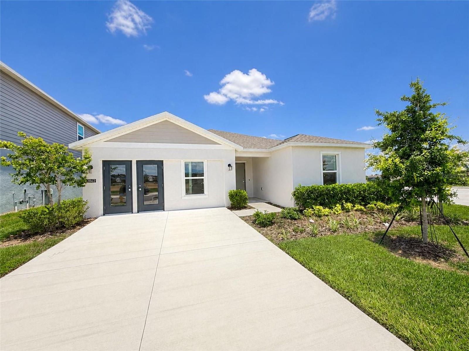 Why wait to build when you can own this like-new, never-occupied former model home, ready for its very first owners? Showcasing designer-selected finishes and model-quality upgrades throughout, this exceptional residence offers the rare opportunity to enjoy new construction appeal without the wait time.

Thoughtfully designed for both comfort and functionality, this beautifully appointed single-story home features a spacious open-concept layout that seamlessly connects the kitchen, dining area, and family room—creating an ideal setting for both everyday living and effortless entertaining. Sliding glass doors extend the living space outdoors, providing easy access to a covered lanai and year-round enjoyment of Florida’s outdoor lifestyle.

Privately positioned at the rear of the home, the luxurious owner’s suite serves as a true retreat, complete with a spa-inspired en-suite bathroom and generous walk-in closet. At the front of the home, three additional bedrooms offer excellent separation and flexibility—perfect for family, guests, or a home office. A versatile flex space further enhances the layout, easily adapting to your needs as a media room, playroom, fitness area, or workspace.

Residents enjoy access to resort-style amenities, including a sparkling community pool and multiple sports courts, fostering an active and engaging neighborhood environment. Ideally located just minutes from historic downtown Lake Wales, homeowners can take advantage of charming local shops, dining, and entertainment, while nearby attractions such as Lake Wales Country Club and the iconic Bok Tower Gardens offer endless recreational opportunities. This move-in-ready former model home presents a rare opportunity to own a never-lived-in residence with premium finishes in one of Lake Wales’ most desirable communities.