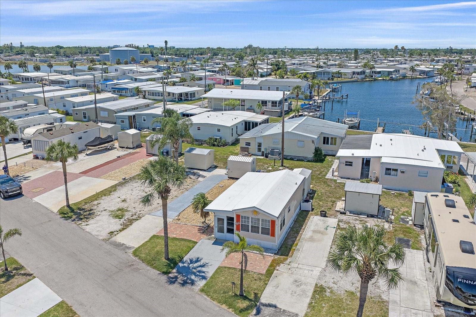 Impeccably cared for and move-in ready, this SUNSHINE COTTAGE is a must-see park model in TROPIC ISLES Co-Op — a highly sought-after 55+ resident-owned waterfront community!  This charming 1-bedroom, 1-bath home offers comfortable coastal living with a spacious living room featuring a peaceful peek of Terra Ceia Bay.  Enjoy Florida’s outdoor lifestyle with a huge lanai, private back patio, and beautifully paved front sitting area that also works perfectly as golf cart parking pad. No lot rent.  $325 monthly maintenance fee covers water, garbage and recycling collection, sewer, park management and access to all amenities including the marina.  Tropic Isles is known for its active lifestyle, friendly atmosphere, and exceptional amenities. Residents enjoy access to a full-service marina and bait shop, fitness center, library, shuffleboard courts, heated/chilled pool and spa, social rooms, and endless community activities including aerobics, movie nights, book clubs, line dancing, and more.  Whether you're searching for a seasonal getaway or your forever home, this property offers the perfect blend of relaxation, recreation, and waterfront community living.  Schedule your private showing today and start enjoying the Florida lifestyle you’ve been dreaming of!