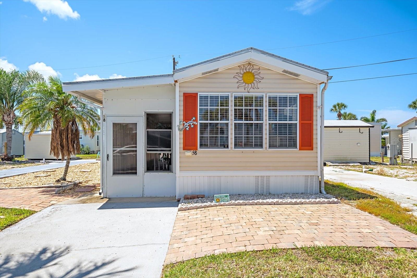 Impeccably cared for and move-in ready, this SUNSHINE COTTAGE is a must-see park model in TROPIC ISLES Co-Op — a highly sought-after 55+ resident-owned waterfront community!  This charming 1-bedroom, 1-bath home offers comfortable coastal living with a spacious living room featuring a peaceful peek of Terra Ceia Bay.  Enjoy Florida’s outdoor lifestyle with a huge lanai, private back patio, and beautifully paved front sitting area that also works perfectly as golf cart parking pad. No lot rent.  $325 monthly maintenance fee covers water, garbage and recycling collection, sewer, park management and access to all amenities including the marina.  Tropic Isles is known for its active lifestyle, friendly atmosphere, and exceptional amenities. Residents enjoy access to a full-service marina and bait shop, fitness center, library, shuffleboard courts, heated/chilled pool and spa, social rooms, and endless community activities including aerobics, movie nights, book clubs, line dancing, and more.  Whether you're searching for a seasonal getaway or your forever home, this property offers the perfect blend of relaxation, recreation, and waterfront community living.  Schedule your private showing today and start enjoying the Florida lifestyle you’ve been dreaming of!