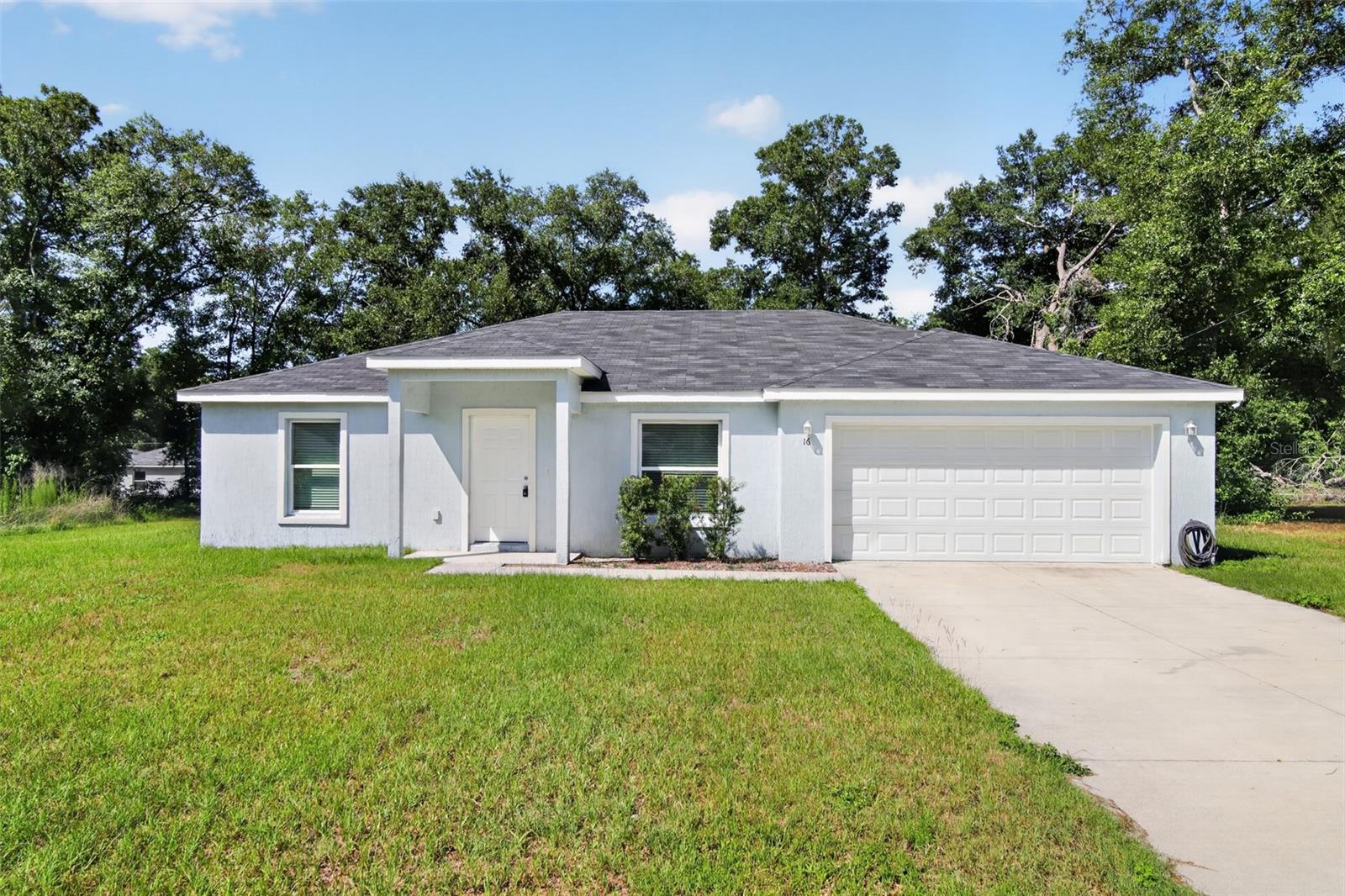 Welcome to 16 Spring Loop Ct in Ocala, a beautifully maintained 2022-built home offering the perfect blend of modern design, comfort, and value. This 3-bedroom, 2-bath residence features an open-concept floor plan that seamlessly connects the spacious living, dining, and kitchen areas, creating an ideal space for both everyday living and entertaining. The thoughtfully designed kitchen offers ample cabinetry, generous counter space, and a functional layout that overlooks the main living area. The private primary suite provides a relaxing retreat with an en-suite bath and walk-in closet, while two additional bedrooms offer flexibility for guests, family, or a home office. Situated on an oversized lot of approximately 0.49 acres, the property offers abundant outdoor space for recreation, gardening, pets, or future enhancements. Built in 2022, the home offers the peace of mind and energy efficiency of newer construction while enjoying a convenient location near shopping, dining, schools, parks, and major roadways. Whether you're a first-time buyer, downsizing, or looking for a move-in-ready investment opportunity, this Ocala gem is ready to welcome you home.