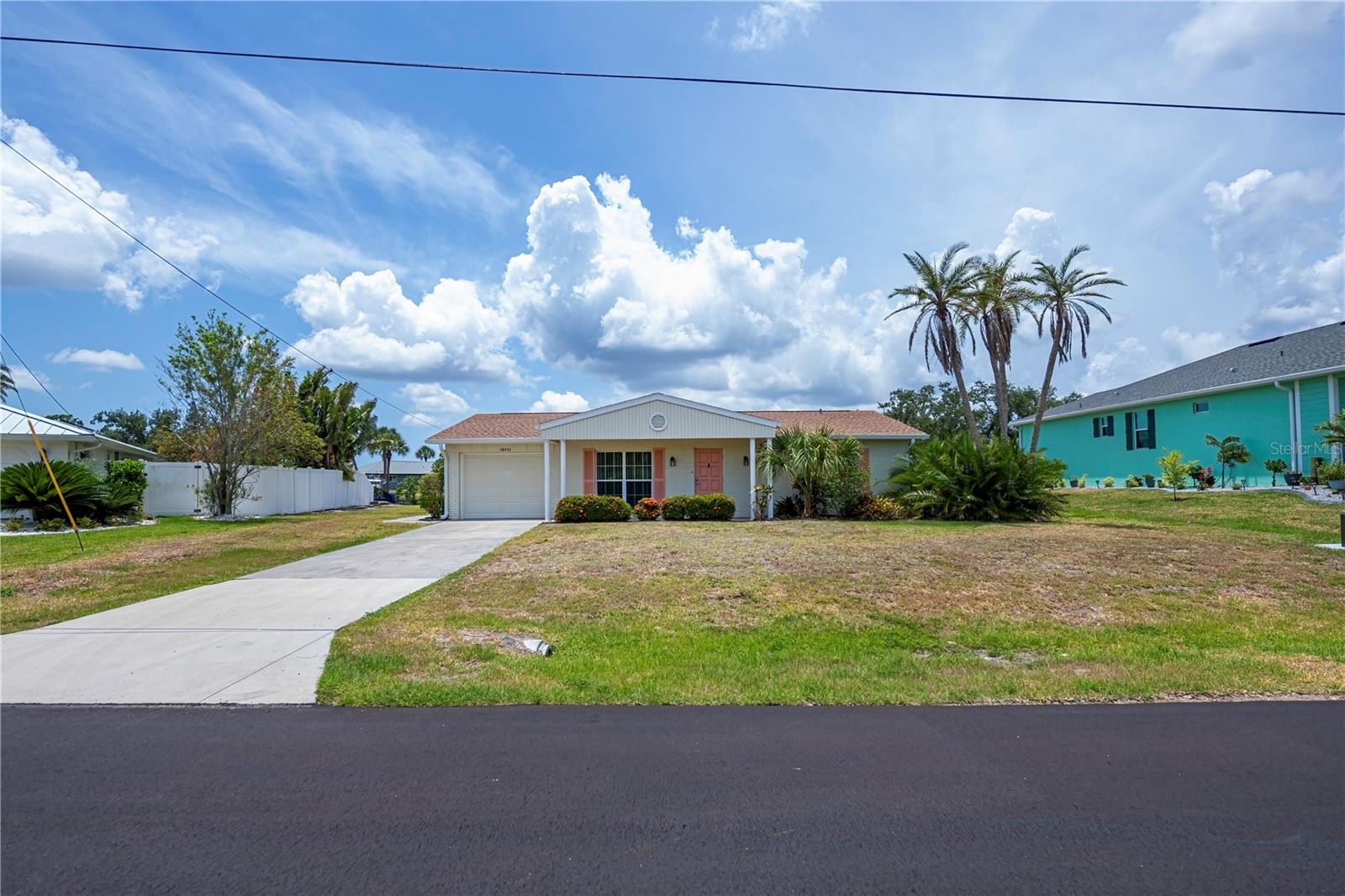 Your Waterfront Oasis Awaits in Port Charlotte! Embrace the ultimate Florida lifestyle in this charming, classic waterfront pool home located in the heart of Port Charlotte! Nestled on a generous 0.27-acre lot, this 3-bedroom, 2-bathroom gem offers the perfect blend of relaxation and recreation, right in your own backyard. With 1,187 square feet of efficiently designed living space, this 1975-built Florida classic boasts a bright, welcoming layout. Natural light spills through the windows, highlighting an open flow that connects the living and dining areas—perfect for entertaining or cozy nights in. The three well-appointed bedrooms provide plenty of space for family, guests, or a dedicated home office, while the attached 1-car garage ensures your vehicle or extra gear stays secure. Step out back and let your worries melt away! Your private, screened-in pool area is ready for morning swims, weekend barbecues, and sunset cocktails. Beyond the pool lies the true star of the show: your own piece of Florida waterfront. Imagine casting a line from your backyard, watching local wildlife, or launching a kayak or small boat right from your property. Located on a quiet, palm-lined circle in a highly desirable section of Port Charlotte, you're perfectly positioned to enjoy everything Southwest Florida has to offer. You are just a short drive away from world-class fishing and boating on Charlotte Harbor, pristine Gulf Coast beaches (Boca Grande, Englewood, and Venice), top-tier golfing, shopping, and dining, and the newly developed Sunseeker Resort. Whether you are looking for a year-round residence, a sunny winter retreat, or a lucrative vacation rental investment, 18451 Goodman Cir is a rare waterfront find with endless potential. Don’t let this slice of paradise slip away. Schedule your private showing today and start living the Florida dream!