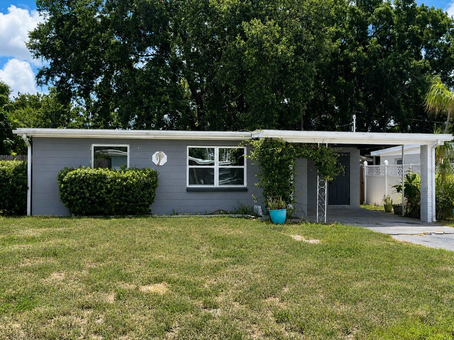 Charming 2BR/1BA Home in Desirable Orange Lake Village! Just two blocks from Lake Seminole and minutes to the Gulf beaches, this move-in-ready home offers an unbeatable mid-county location. Renovated in 2022 with a stylish kitchen featuring granite countertops, tile backsplash, and newer appliances. Enjoy gorgeous polished vintage terrazzo floors, freshly painted interior walls, newer A/C, newer windows, and a roof replaced in July 2023. French doors open to a versatile bonus room perfect for a home office, den, playroom, or sunroom. The fenced backyard includes a storage shed, tiled patio, mature landscaping, and a cozy firepit seating area. Carport parking and all appliances, including stackable washer/dryer, are included.