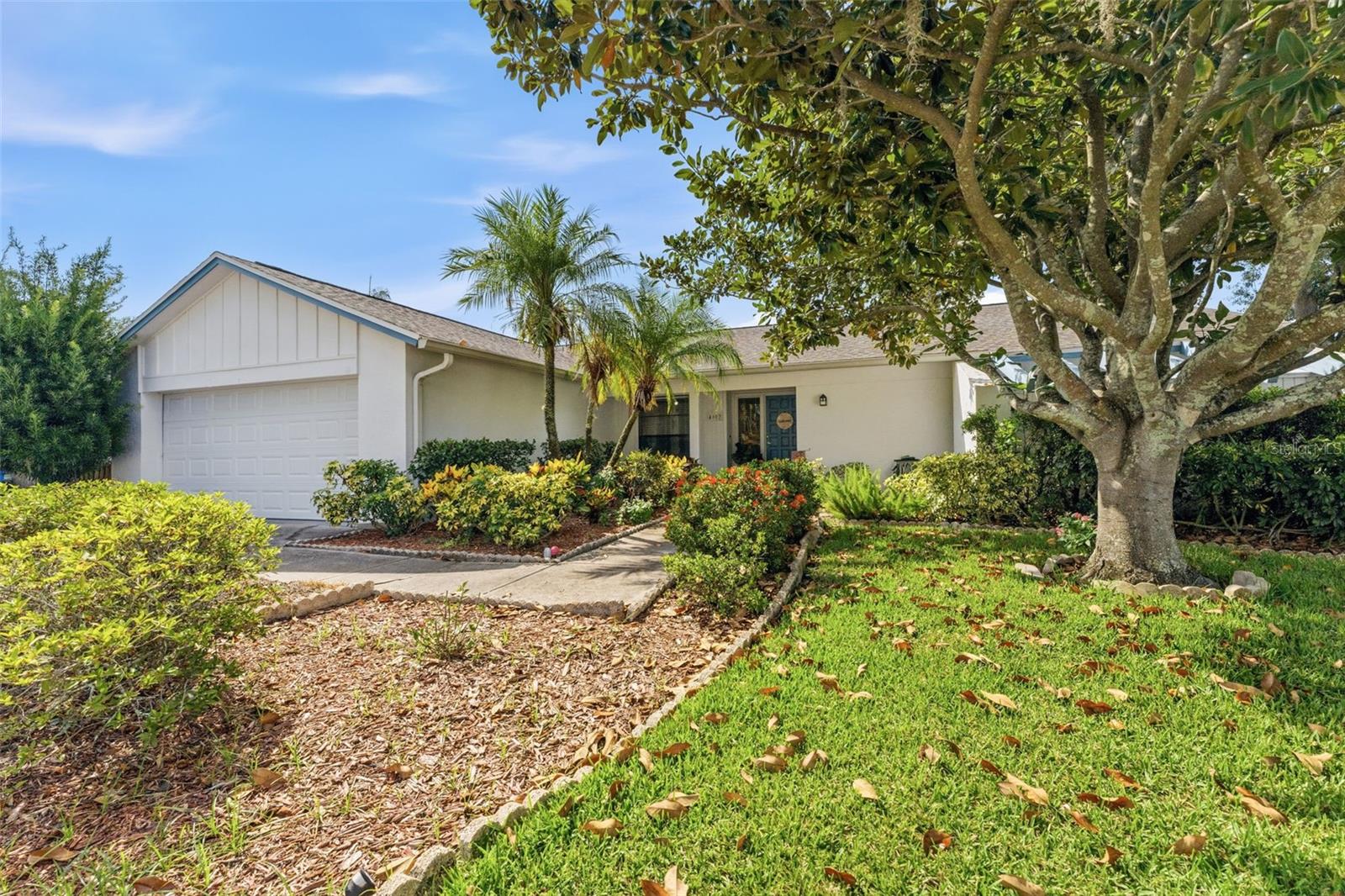 Welcome home to this beautifully updated pool home in the highly sought-after Carrollwood/Northdale area! This spacious residence offers an open and inviting floor plan with rich wood-look flooring, soaring vaulted ceilings, and abundant natural light throughout. The heart of the home is the stunning remodeled kitchen featuring white shaker cabinetry, granite countertops, stainless steel appliances, a large center island with seating, and seamless flow into the family room. The impressive family room showcases decorative ceiling beams, a floor-to-ceiling stone fireplace, and sliding glass doors leading to the outdoor living space. The oversized primary living and dining areas provide plenty of room for entertaining family and friends. Outside, enjoy your private backyard oasis complete with a screened lanai, sparkling pool, and fully fenced yard—perfect for relaxing, grilling, and year-round Florida living. Nestled on a quiet street with mature landscaping and excellent curb appeal, this home is conveniently located near top-rated schools, parks, golf courses, shopping, dining, and major roadways, providing easy access to everything Tampa has to offer. Don't miss this opportunity to own a move-in ready home in one of Tampa's most desirable communities!