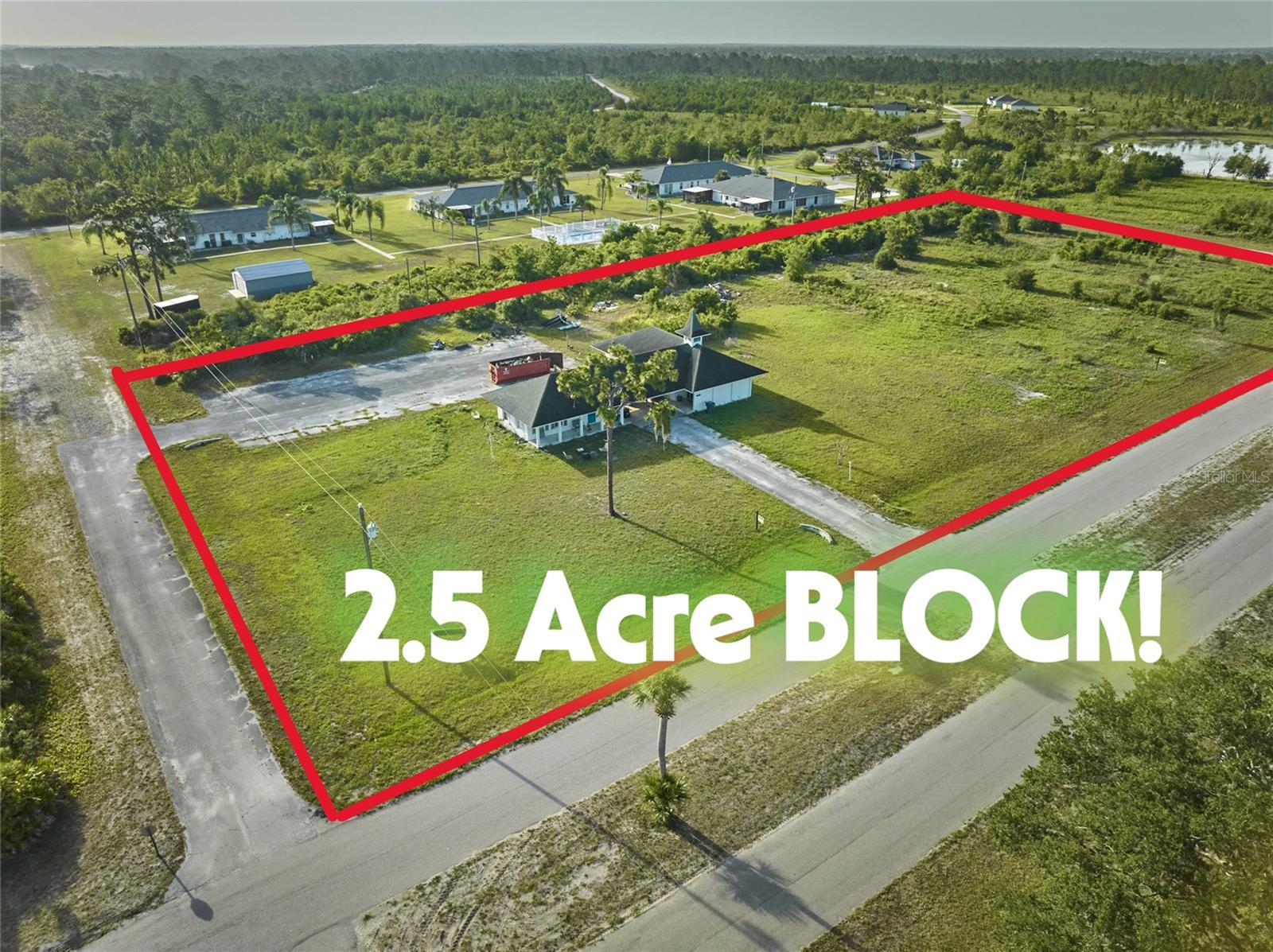 AN ENTIRE BLOCK IS FOR SALE, 2.5 ACRES. This building, sitting on 2.5 cleared acres, was built as a church and is now set up as a home plus rental. Investors can purchase the land and develop or renovate the current building on-site. There are two buildings connected by a breezeway, so your adult child, parent, or in-law can be under roof, but have privacy. The first building has a living room, bedroom, kitchen and two bathrooms. The second building has one large unfinished studio, with utility/bathroom space. What an opportunity to create a one-of-a-kind property! You can rent both sides or live in one and rent out the other. The huge parking lot means you can invite all your friends over to your 2 and a half acres for flag football, volleyball, or soccer! Located across from the United Methodist Church, you will enjoy hourly chimes throughout the day. This property is part of Indian Lake Estates (ILE) and enjoys the amenities of the golf course, fishing pier, marina, pavilion, bathhouse, and beach area, plus all the community land fronting the largest lake in Polk County, Lake Weohyakapka. There are always activities at the clubhouse, just over a mile away: Dominoes, Cards, Karaoke, Trivia Night, Bingo, Concerts, Dances, or just hang out with friends at the 19th Hole, open 7 days a week. There is a public golf course, with an 18-hole course and a 9-hole, executive, 3-par course (no cost to residents who pay their annual license fee). And the bakery is just down the street! There is NO HOA, but the community does have an annual license fee, per parcel, to help maintain the private roads. ILE is the perfect blend of privacy and community. Call your agent and see if this might work for you!
