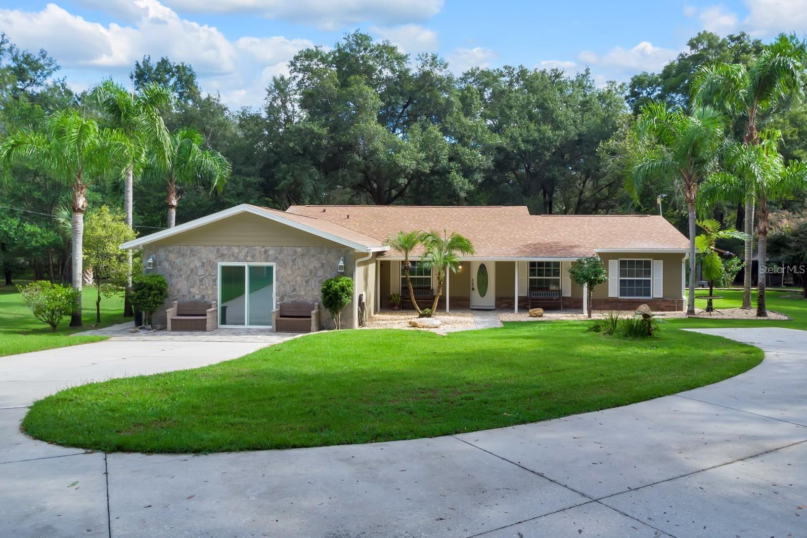 Discover the perfect blend of PRIVACY, ACREAGE AND ENDLESS possibilities offering the ideal setting for MULTI-GENERATIONAL LIVING, FARMING, RECREATION, OR creating you own PRIVATE RETREAT on 2.5 ACRES in the heart of Apopka. This spacious residence features 4 bedrooms, 4 bathrooms, and a sparkling SCREENED-IN POOL,  offering an exceptional lifestyle for those seeking room to LIVE, GROW AND CREATE. Designed for both comfort and functionality, the home boasts an inviting OPEN-CONCEPT FLOOR PLAN, spacious living areas, and thoughtfully designed rooms that accommodate today’s lifestyle needs. A versatile front room can easily serve as a home OFFICE, GYM, STUDY OR PLAYROOM. The PRIMARY SUITE offers a private retreat with an EN-SUITE BATHROOM, while the home’s numerous upgrades provide peace of mind, including NEW WINDOWS, a NEW ROOF  installed in October 2025, a NEW AC UNIT in 2026, a NEW WATER HEATER, and a recently CLEANED AND SERVICED SEPTIC SYSTEM. SOLAR HEATING PANELS further enhance efficiency and convenience. Step outside and embrace the possibilities. The property is fully equipped for outdoor living and recreation, featuring an automatic GATED ENTRANCE, PRIVATE DRIVEWAY, covered lanai, OUTDOOR BATHROOM, RV and boat parking, and ample space for MULTIGENERATIONAL LIVING. Surrounded by mature landscaping and FRUIT TREES, including AVOCADO, MANGO, AND LIME TREES, this estate offers a true farm lifestyle. With NO HOA restrictions, this extraordinary property presents endless opportunities to expand and customize. Create your dream estate, add horse stables, establish a hobby farm, cultivate gardens, develop a commercial nursery, or explore future parcel opportunities. Rarely does a property offer this level of privacy, versatility, and potential, all while being conveniently located near shopping, dining, major highways, and Central Florida attractions. Come experience your own paradise and imagine the possibilities. CALL TODAY AND SCHEDULE YOU PRIVATE SHOWING!