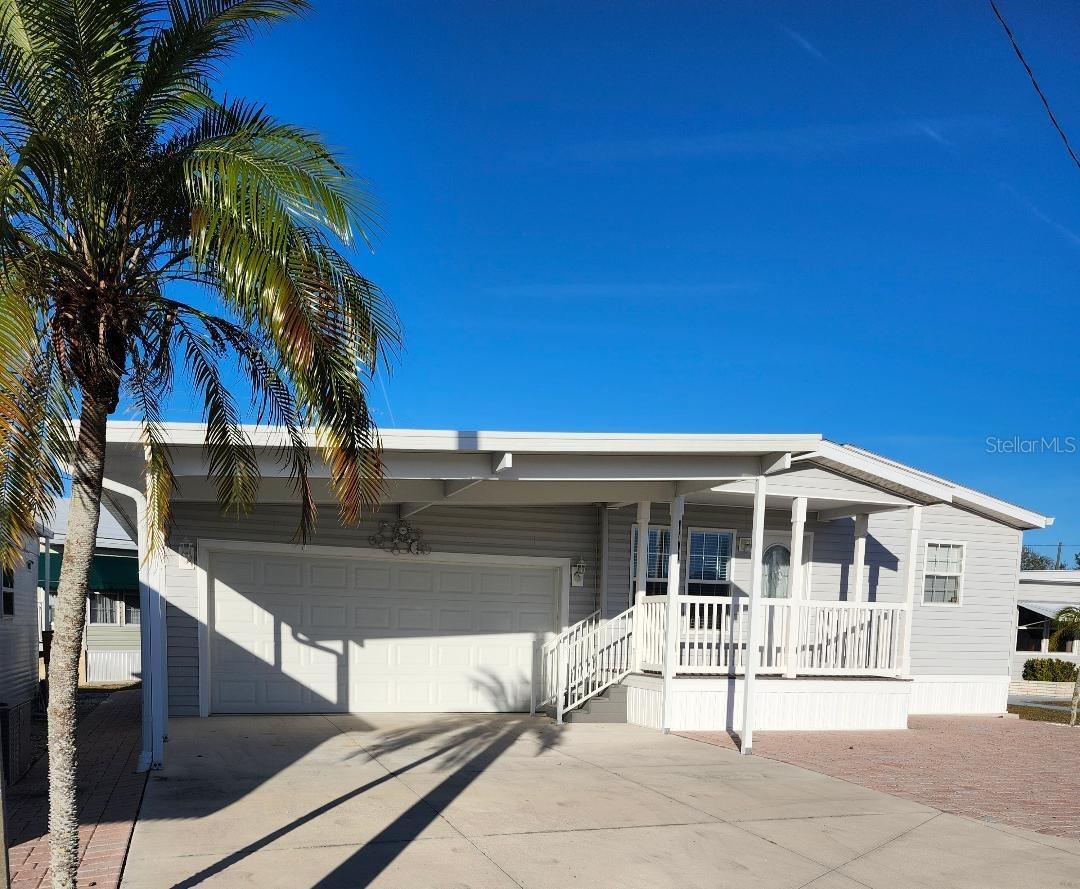 This 2019 Jacobsen "IMPERIAL" model Double Wide manufactured home offers Three bedrooms and Two baths, plus an attached 30'x20' two car GARAGE in the highly desired, active 55+ Trailer Estates community. Buyers wait months for new models to be manufactured and installed, but you can MOVE right in! You are greeted by a large covered front porch leading into bright, open-concept living and dining spaces. All drywall interior. Eat in space in Kitchen. Primary Bedroom suite with roomy walk-in closet in the Primary ensuite Bath. Two more Bedrooms and an additional Bath with plenty of room for guests. Separate Laundry Room just down the hall with access into the huge garage. No lot rent, you own the land. Park Fees are included into annual real estate taxes. Boaters have direct access to Sarasota Bay from the Marina. Trailer Estates community offers so many options for a great day! Enjoy the large, heated community pool, hot tub, gym and wood shop. The community buzzes with pickleball, shuffleboard, kayaking, horseshoes, bocce, dancing and more. A US Post Office on site. 10 minutes to the SRQ Airport. Convenient to shopping, restaurants, the Arts and everything in Bradenton/Sarasota. Sold furnished. Bring offers!