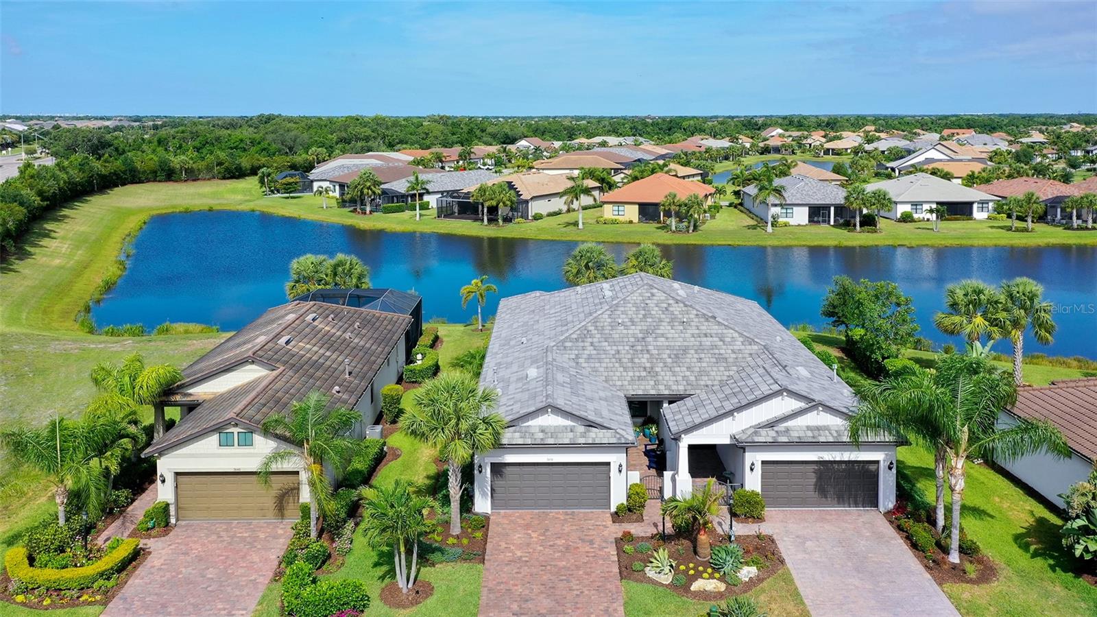 Beautifully landscaped, well maintained home situated on a premium lot, at end of a quiet cul-de-sac. From the moment you enter, you will feel a sense of calm as you take in the serene water views from almost any room. Spacious floorplan with extended covered lanai create a relaxed setting for entertaining and family gatherings. Tasteful upgrades from floor to ceiling, including plantation shutters throughout, Quartz countertops, porcelain tile on the diagonal, neutral custom painted walls, tall ceilings with 8ft doors, 5¼ in crown molding and baseboards. Custom light fixtures, mirrors and ceiling fans with additional recessed lighting and dimmers. Soft close cabinets throughout, dual sink vanity and enlarged shower in primary bath. 48in upper kitchen cabinets with lower pull-out drawers. Extra deep closet built in the “drop zone area” and upper and lower cabinets added in the laundry room. All closet systems designed by Closet Tech to provide maximum organization and storage. Most appliances are newer, allowing you to enjoy living in your new home, stress free. This top rated “Over 55 Del Webb community” provides unlimited activities, special interest groups, resort style and lap pools, bocce ball, pickle ball, tennis, and water sports. There is a restaurant on property, live entertainment, and a very spacious clubhouse to support your indoor activities. Enjoy the ease of having a well-equipped fitness gym also on property, that includes free weights, weight machines and a full schedule of fitness classes with certified instructors. Restaurants, groceries, movies, and shops are within just a few minutes’ drive with easy access to UTC mall, Mote Marine, Waterside, downtown Lakewood Ranch and Sarasota, and the most pristine, top rated beaches in the country.