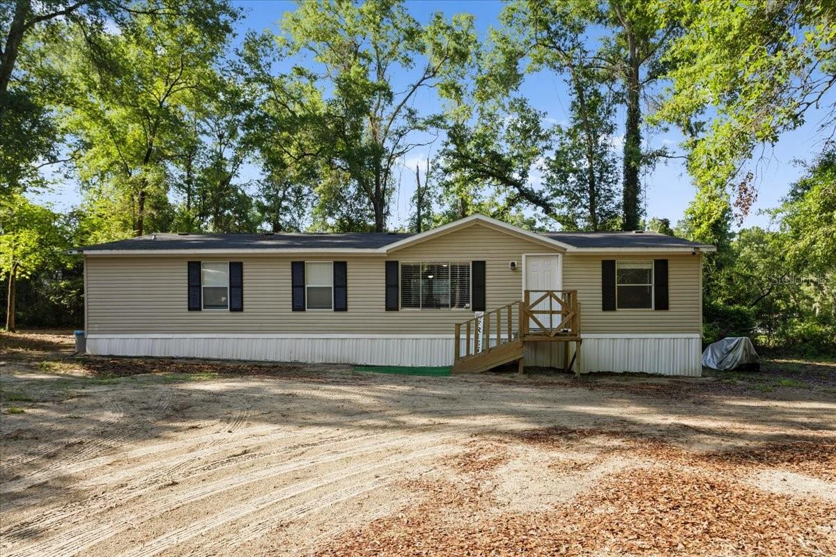One or more photo(s) has been virtually staged. Nestled on 2 private, mostly wooded acres, this beautifully updated home offers peaceful country living with plenty of room to enjoy the outdoors and nature around you. Nearly the entire home was remodeled in 2024, including a new roof, A/C, water heater, updated kitchen, and renovated bathrooms. Inside, you’ll find a spacious open living area perfect for gathering, along with a desirable split-bedroom floor plan. Off the primary bedroom is an extra flex space that would be great for an office, nursery, home gym, or even an added walk-in closet! Accessibility ramps along one side of the home provide additional convenience. Outside, there’s ample space to play, relax, or explore, plus a storage shed for your tools and equipment. Come check it out today!