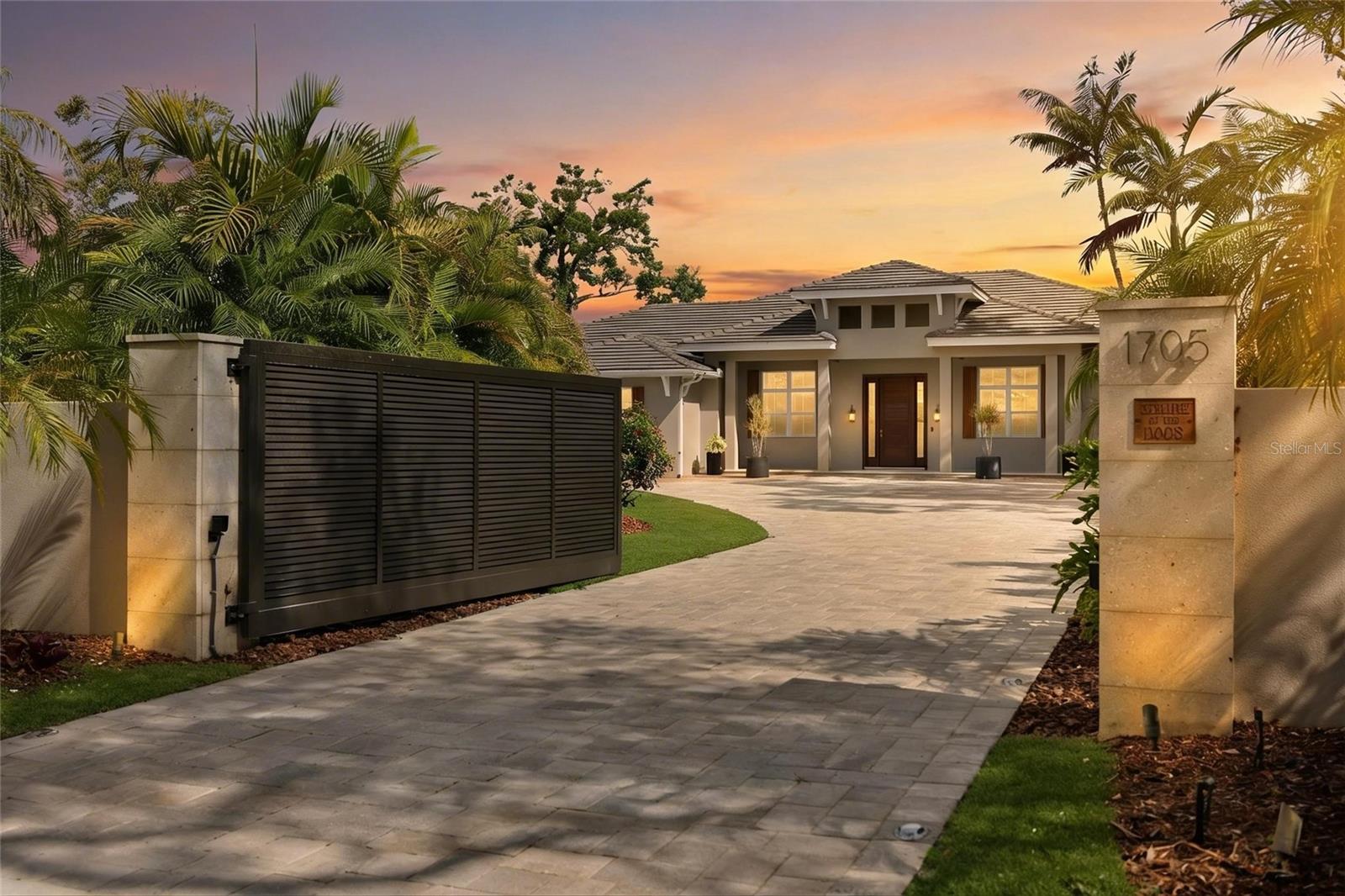Under contract-accepting backup offers. Tucked behind a gate on a quiet, private road in one of Sarasota’s most sought-after neighborhoods, this is the kind of property families wait years for—where space, privacy, and lifestyle all come together just minutes from everything.

Located West of Trail, just blocks from Southside Elementary and Southside Village, and a short drive to downtown Sarasota and Siesta Key Beach, this estate offers a rare balance: a secure, expansive family compound in the heart of it all.

Set on over half an acre and fully gated, fenced, and lushly landscaped, the property is designed for those who want room to live, grow, and entertain privately—without sacrificing convenience.

The main residence spans nearly 4,000 square feet with 5 bedrooms, 4 full bathrooms, 2 half baths, a private office, and a large game room or playroom with its own wet bar—perfect for families who need flexibility in how they live day-to-day. Whether it’s a dedicated workspace, kids’ zone, or media room, the layout adapts to your lifestyle.

The kitchen is built for real life and entertaining alike, featuring Viking appliances, generous storage, and an open flow into the main living areas and outdoor spaces. Every bedroom includes an ensuite bath, offering comfort and privacy for family and guests.

Step outside and the home truly opens up. A large covered lanai with outdoor kitchen overlooks the heated, self-sanitizing saltwater pool and spa, with a sunken firepit seating area creating a natural gathering space for evenings with friends or family. A dedicated pool bath adds convenience, while the entire outdoor experience is designed for year-round Florida living.

For those who need more than just bedrooms, the detached guest apartment above the garage provides over 700 square feet of private living space—ideal for multi-generational living, a nanny suite, long-term guests, a studio, or a secluded home office.

And for the car enthusiast or collector, this property stands apart. With 5+ climate-controlled garage spaces—including room for lifts—plus a large all-season carport with motorized louvers, you have the flexibility to showcase, protect, and enjoy your collection. The garages are outfitted with SwissTrax flooring, vacuum systems, and Mitsubishi in-wall AC units—built with intention, not as an afterthought.

Beyond comfort and design, the home is equipped for peace of mind. Impact windows and doors, a full CCTV security system, smart home integration, and a Generac generator ensure both safety and ease of living.

This is a home for a family who wants it all—space to spread out, privacy to feel secure, proximity to top schools and amenities, and the ability to live an active Sarasota lifestyle, whether that’s golf cart rides to dinner, beach days on Siesta Key, or quiet evenings at home.

Because homes that check every box like this—location, land, layout, and lifestyle—are rare.

And when they come up, they don’t last.