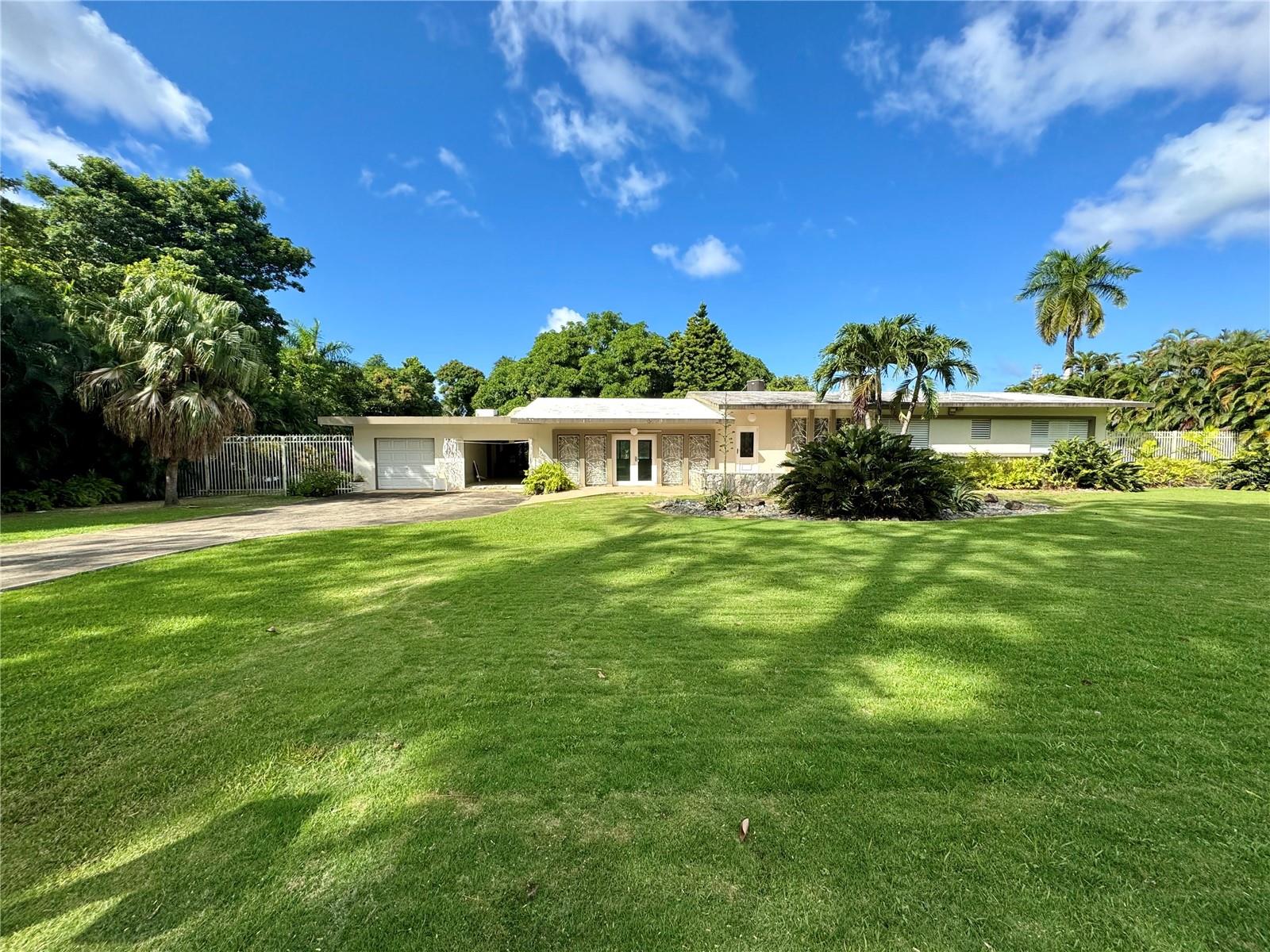 Nestled in the exclusive enclave of San Patricio, Guaynabo, this mid-century one-level residence seamlessly blends classic charm with modern potential. Offering approximately 3,000 square feet of interior space, this home provides a spacious canvas for your unique vision.

The expansive 5,000 square meter flat lot includes both front and back yards, perfect for entertaining or crafting your dream outdoor oasis.

Located in a gated community with 24/7 security, this property offers the ideal combination of privacy, convenience, and the opportunity to create your perfect home.