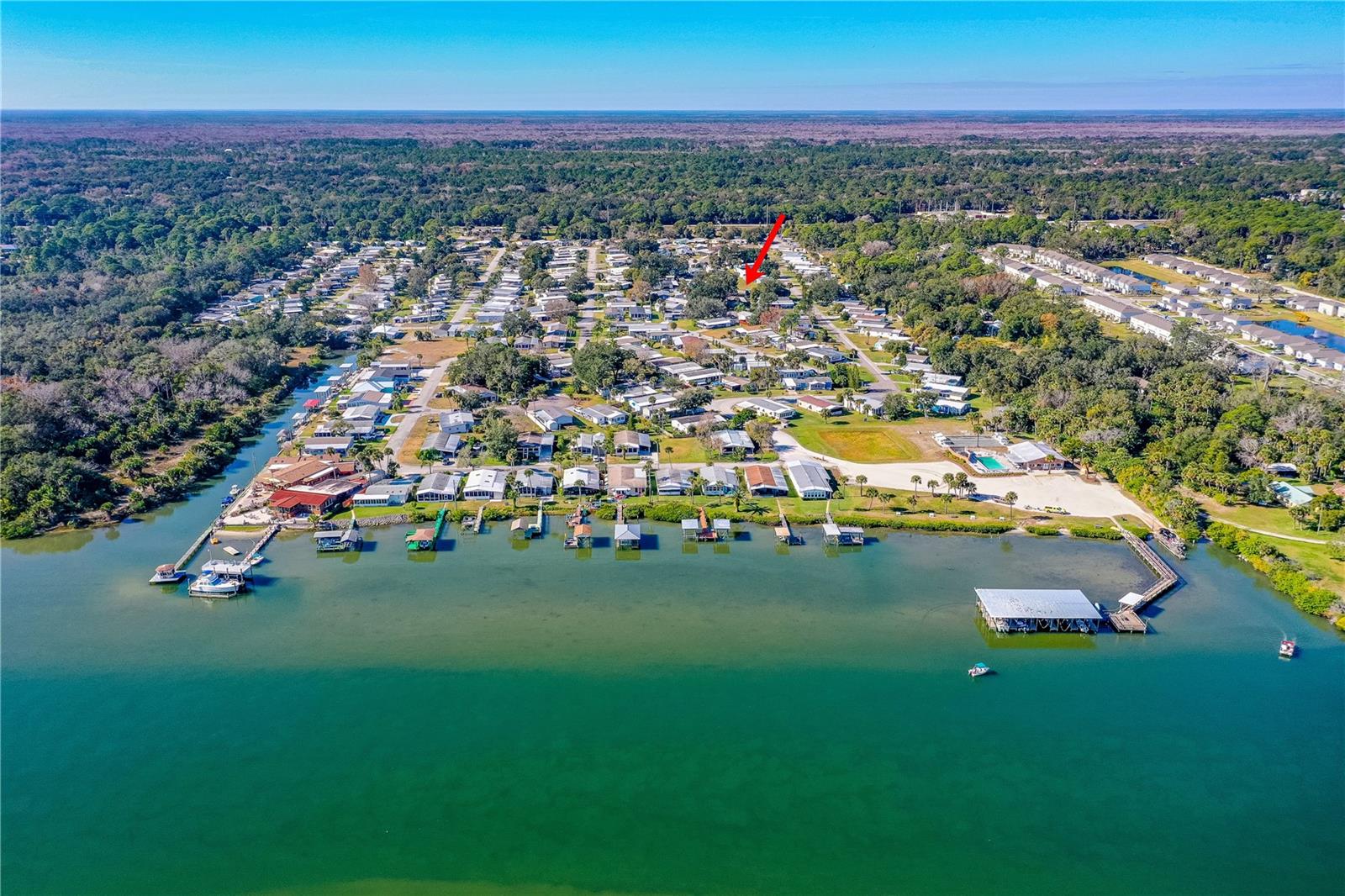 Terra Mar Village is the Florida lifestyle, with a rare opportunity to build in a desirable waterfront community. One of the last vacant lots, this cleared, and level 50 x 100 corner lot sits on a quiet cul-de-sac. Zoned M5, it allows a new manufactured home, relocation of an existing manufactured home, or construction of a single-family concrete block or wood/metal-frame home. A county-approved variance for extended setbacks is in place, and site plans are available for a 2-bedroom, 2-bath home with loft, two driveways, and carport. Located in Flood Zone X, flood insurance is not required. This all-age community is zoned for the New Smyrna Beach school district. Amenities include two pools (one heated), clubhouse, bocce ball, shuffleboard, RV and boat storage, boat slips (lease available), private boat ramp with Intracoastal access, boat dock, and new fishing pier. No lot rent, low fees, minutes to shopping, dining, and New Smyrna Beach.