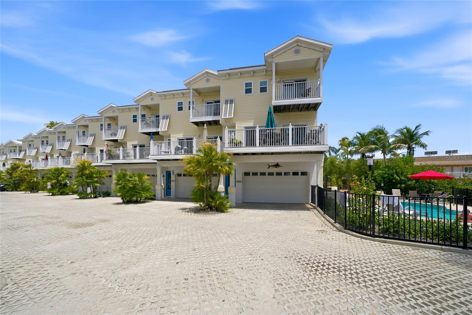 Location is everything at this highly desirable Bermuda Bay Club on sought-after Gulf Drive in Bradenton Beach, this exceptional 3-bedroom, 2.5-bath townhome is calling your name!   The unique end unit location overlooks the pool thru the mangroves creating spacious natural ambience. Open bright floor plan living area w/ ceramic plank tile flooring for easy clean up.  Sliders off the dining area & living room plus bonus window allow natural light to bathe the room in sunshine. With views from both the Gulf and the Bay from the private deck featuring Trex decking and heavy duty Amish plywood outdoor furniture, you will never want to leave.  The updated kitchen features custom cabinetry, quartz countertops, and newer appliances, gorgeous light fixtures while all bathrooms have been completely remodeled with quality finishes and modern design.  All updated impact windows and slider doors throughout including the garage door.  Upstairs spacious primary ensuite includes its own private deck w/Gulf and Bay views. The other two bedrooms consist of a bunk bed (queen and Xlong twin) and the other a Queen Murphy bed giving plenty of room for guests and share a full bathroom.   For peace of mind, Milestone inspection completed, and all building inspections current and up to date within a healthy, well-maintained condominium community. Community pool and Fishing pier to Bay side. Walk across the street to the beach with easy crosswalk. Trolley stop directly in front for easy access to hop on and go explore.  Two car garage is perfect for storing bicycles, kayaks & all your beach toys. Convenient main floor laundry & powder room.   Bermuda Bay Club amenities include a heated pool, barbecue area, private bayfront access path, and deeded beach access directly across the street providing the resort style experience today's vacation guests are searching for.  This offers a rare opportunity for investors seeking strong income potential combined with long-term value appreciation. Anticipated annual gross revenue from rentals approaching $100K annually.   Investment opportunities with updated systems, reduced deferred maintenance concerns, oversized garage space, beach access, water views, and prime island location are increasingly difficult to find. Don’t miss out on your opportunity to own a high-demand coastal property in one of Bradenton Beach's most desirable communities. Offered turnkey furnished with a few seller exclusions.