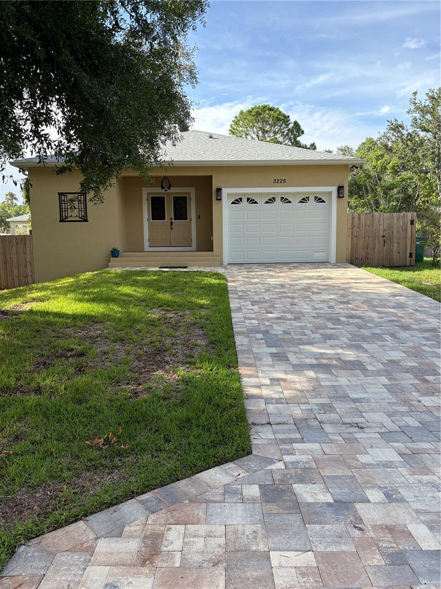 HOME STAYED 4+' ABOVE FLOOD WATERS!! Come walk through this home and discover what makes it so special. This brand-new residence is meticulously crafted with attention to detail, featuring a fully block exterior for strength and durability. Step inside to find a kitchen outfitted with custom wood cabinets, complete with slide-out drawers and cabinets, and a massive pantry. Enjoy a lifetime warranty on the Quartz countertops, which include an island with a double-basin sink, a dishwasher, a cutting board integrated into the sink, and a microwave seamlessly built into the cabinetry. The kitchen is equipped with stainless steel appliances and a stainless steel hood vent for the range. The open concept design of the kitchen and living room provides a versatile space for your imagination to flourish. Additional features include a new septic system, double-insulated hurricane impact windows and doors, and hurricane glass in the garage door. The front door also has hurricane impact glass for enhanced security and protection. Inside, you'll appreciate the high ceilings at 9'4" and the primary bathroom, which boasts a double vanity, a luxurious walk-in shower with a seat, and an impressive 6' backlit, anti-fog mirror with extra lighting options. Above the front porch, you'll notice a charming wood ceiling that adds a unique touch. The garage is designed for convenience, with an 8' high and 12' wide door, complemented by approximately 14' ceilings, providing ample space for vehicles and storage. Additional storage is available in the attic, accessible via a pull-down ladder, featuring a plywood floor with an extra 100 sq ft of storage, and convenient attic lights. The home is equipped with an inverter-driven high-efficiency heat pump air conditioning system, ensuring optimal comfort and energy efficiency year-round, with a 12-year parts and labor warranty. Located in a secluded neighborhood just down the road from St. Petersburg Fire Station #14, this home offers easy access to all of Tampa Bay. The neighboring lots are currently being developed, promising a future neighborhood full of new housing.