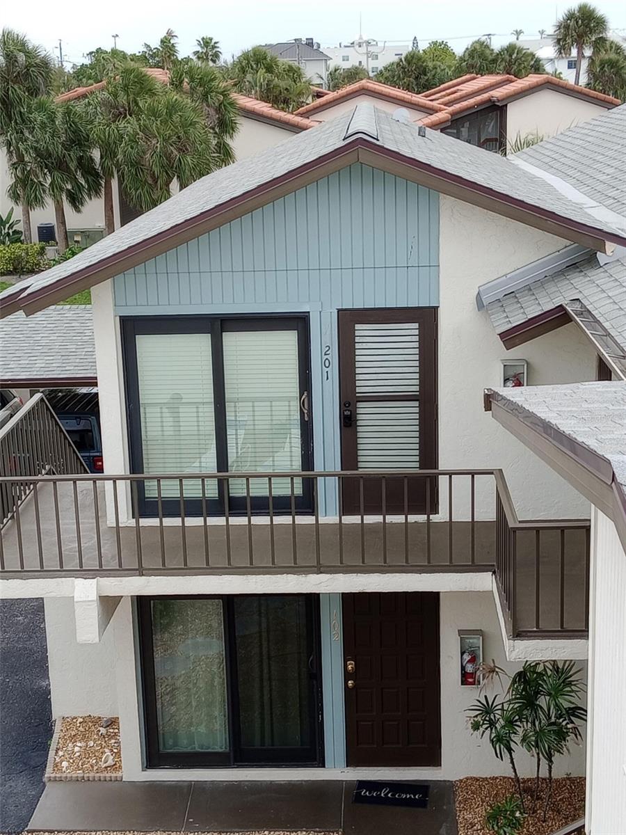 Situated on the second story of a 4 unit building within the complex this turnkey Lido Key condo looks and feels like a cozy beach cottage.
Enjoy morning coffee on your south facing balcony. Refresh yourself in the beautiful blue Gulf waters at the end of the street then pop over to the adjacent beach bar for lunch, happy hour, or sunset! Walk (or rent a bike) to nearby St Armands Circle and enjoy its myriad of shopping and dining choices - day and night.
There's a romantic fireplace (heat optional)for curling up with a good book if we have a cold snap, a full size W/D, lots of closet space, a carport, and (drumroll)..... excellent income potential!
Why is the price higher than some? Because of the income potential. The complex is one of the few on Lido Key that doesn't require long term rentals - this allows you to maximize income. It is very popular on Airbnb and VRBO, with many guests returning regularly year 'round. Summer rates for this floorplan are apprx. $240 nt. and Season '27 bookings are $365+ nt.. 
Upgrades have created a roomy space that adapts well to dual purpose use. While there's a carport, a car isn't really needed to get around the island, and there is a free trolley to/from Whole Foods and adjacent Main Street restaurants and shops, as well as an almost free taxi type service.
