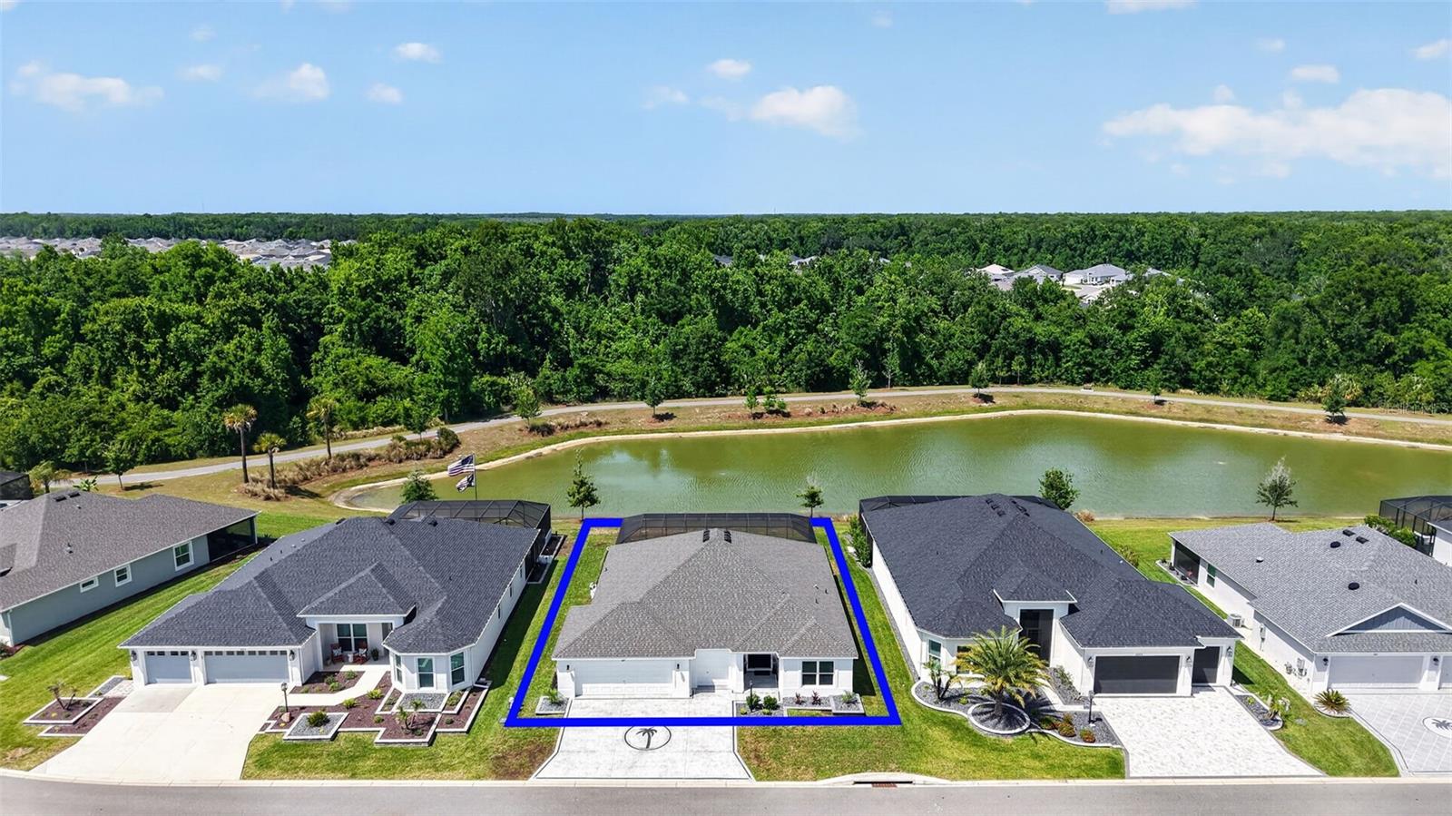 INDULGE in REFINED FLORIDA LIVING in this EXTRAORDINARY, TURNKEY, 3/3 Designer Indigo showcasing SWEEPING WATERFRONT VIEWS, RESORT-STYLE SWIMMING POOL and SPA with a SUN DECK, OVERSIZED 660sf 2-CAR + GOLF CART GARAGE, and possible IN-LAW SUITE - perfect for multigenerational living - located in the VIBRANT Village of Lake Denham! This AMAZING home INCLUDES EVERYTHING YOU NEED! Constructed in 2023 with meticulous finishes throughout, this nearly new home embodies effortless Florida living with timeless architectural appeal! ENHANCED TIERED hardscaping and DECORATIVELY PAINTED drive and walkways lead to a covered vestibule and side-lit entry, creating a striking first impression. A grand foyer boasting an ENTRY CLOSET opens to the EXPANSIVE OPEN-CONCEPT interior where NATURAL LIGHT, SOARING ceilings, and seamless design create an atmosphere of UNDERSTATED LUXURY! Offering both beauty and durability, RICH LUXURY VINYL PLANK flooring flows seamlessly throughout the living, dining, and kitchen. The SHOW-STOPPING GOURMET kitchen features WHITE SHAKER cabinetry, gleaming QUARTZ countertops, TILE backsplash, stainless appliances with GAS cooking, and an impressive DOUBLE PANTRY with custom PULL-OUTS. Anchoring the space is an EXPANSIVE CENTER ISLAND with double-sided cabinetry and counter-height seating—perfect for intimate gatherings or casual dining with family and friends. A combination BUTLER’S PANTRY and interior laundry room, adjacent to the kitchen, boasts additional WHITE SHAKER cabinetry with QUARTZ tops, a built-in utility sink, and shelving. Sliding glass doors from either the living room or kitchen open to a SPECTACULAR PRIVATE OUTDOOR RETREAT! Here, a shimmering SWIMMING POOL with BEACH ENTRY and cascading WATERFALL SPA overlook TRANQUIL PANORAMIC WATERFRONT VIEWS, creating a breathtaking setting for entertaining or relaxing! The luxurious primary suite is highlighted by an elegant TRAY ceiling, 2 windows framing water views, and an expansive WALK-IN closet. Its en-suite bath is beautifully appointed with WHITE SHAKER cabinetry with QUARTZ top and DUAL sinks, corner TILE WALK-IN shower with frameless glass, and private water closet. A secluded second bedroom and bath, situated behind a POCKET door, creates a PRIVATE guest wing or potential in-law suite for multigenerational living. The suite features DOUBLE windows, built-in closet, and a beautifully finished bath with WHITE SHAKER vanity and QUARTZ top, frameless glass TILE WALK-IN shower, and a hall LINEN. On the opposite side of the home, the third bedroom, enhanced by a VAULTED ceiling, offers additional flexibility as a guest retreat, office, or den and is complemented by a nearby full bath featuring a WHITE SHAKER vanity with QUARTZ top and TILE tub/shower combination. Completing this remarkable residence is the EXPANSIVE 31’x21’ OVERSIZED GARAGE with EPOXIED floors, providing generous room for vehicles, golf carts, and plenty of storage! The Village of Lake Denham is IDEALLY LOCATED between the NEW Eastport Town Center with shopping, dining, and live nightly entertainment and the ever popular Sawgrass Grove! Close to Franklin, Dabney, Saluki, Homestead, and Olympia Recreation Centers; Southern Oaks and Shallow Creek Championship Golf Course; Farragut Softball Complex; Boosters Bar and Grill; Sophie Doodles Canine Park & more! PLEASE WATCH OUR VIDEO of this MAGNIFICENT TURNKEY WATERFRONT HOME with a POOL and SPA and CALL TODAY to schedule your private showing or virtual tour!