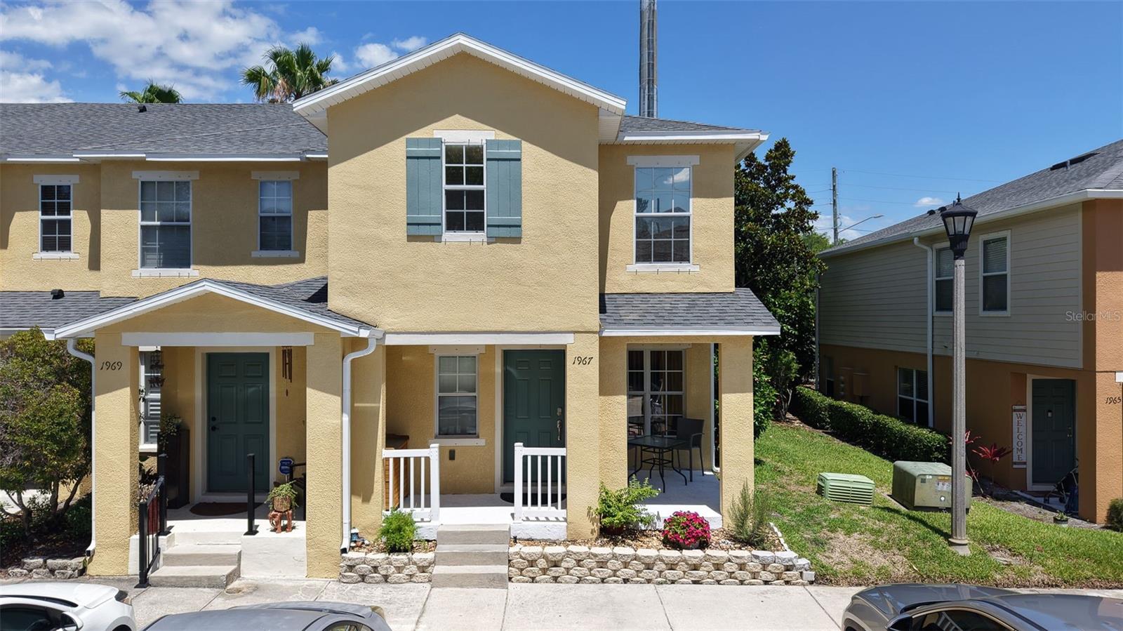 Nestled in a prime Clearwater location with no rear neighbors, this exceptional 3-bedroom, 2-and-a-half-bathroom end-unit townhome offers one of the largest and most versatile open floor plans in the community. The main level welcomes you with abundant natural light, newly updated wood-look laminate flooring, and a stunning, custom-built entertainment center that serves as the focal point of the living room. This spectacular floor-to-ceiling feature boasts extensive shaker-style cabinetry, elegant open shelving with warm accent lighting, and a beautiful natural wood slat accent wall that elevates the entire space. This area flows effortlessly into an expansive kitchen with solid wood cabinetry, creating a flexible footprint that easily configures for a home office, secondary dining, or dual living areas. Transitioning outdoors is seamless with a deep, covered front porch perfect for relaxing and a private rear patio ideal for grilling. Upstairs, the spacious layout features a massive primary suite with dual closets, oversized secondary bedrooms, and a convenient upper-level laundry closet. This energy-efficient property delivers maximum peace of mind and financial optimization, boasting double-pane Low-E windows, protective hurricane shutters that reduce insurance costs, an updated central air conditioning system, and a preferred position within a no-flood, non-evacuation zone. Exceptional convenience defines this neighborhood, where a low-cost HOA covers premium cable, high-speed internet, and comprehensive exterior maintenance including the roof, while community amenities like a playground and newly resurfaced pool sit just steps away. With the scenic Duke Energy Trail accessible directly behind the subdivision and walkable access to local daily necessities, residents enjoy an unmatched suburban lifestyle just a short drive from downtown Dunedin, Safety Harbor, Clearwater Beach, and major regional airports.