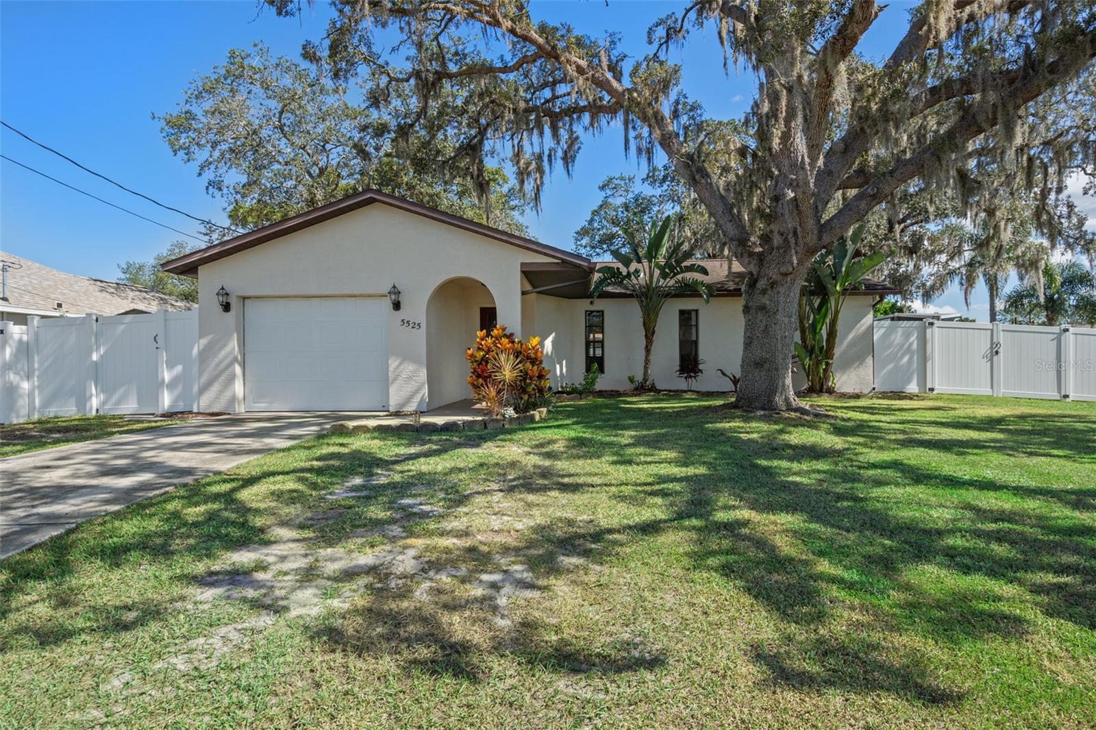 CHARMING and CONTEMPORARY, Welcome HOME to this updated 2 bedroom 2 bath house conveniently located in the Spring Hill community. Enter into the warmth of a SPACIOUS LIVING area leading into the  Kitchen to include stainless steel appliances, breakfast bar, and Dining area with plenty of room for entertaining family and friends. The generous Master bedroom boasts an en suite bathroom and across the split plan you'll find the second bedroom to be generous as well with a recently remodeled common bath. Outdoors you'll find a INCREDIBLE YARD SPACE with room for gardening, play, BBQs, and year round fun and outdoor entertaining with Family and Friends. The white vinyl privacy fence offers a wide double gait for backyard access. NO HOAs , NO CDDs. This Home is conveniently located minutes from shopping and dining. Hernando County is in the heart of FLORIDA'S NATURE COAST, with tens of thousands of acres of State FORESTS, Public access to some of the States most notable RIVERS, LAKES, and of course GULF BEACHES AND BOATRAMPS. Make your FLORIDA DREAM a reality. ENJOY THE PHOTOS . Schedule your showing today !!!