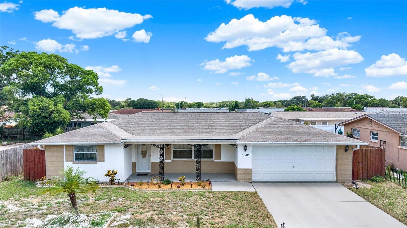 Welcome home to this beautifully maintained 2-bedroom, 3-bath residence in the desirable Colonial Hills community of New Port Richey. Priced at $309,000 and appraised at $315,000, this move-in-ready home offers the rare opportunity to enjoy instant equity along with comfort, convenience, and peace of mind.

Inside, you'll find around 1,400 square feet of bright, inviting living space featuring brand-new luxury vinyl plank flooring, modern fixtures, ceiling fans, open floor plan designed for easy everyday living. The oversized kitchen is complete with matching stainless steel appliances, with an adorable eat in kitchen, and flows seamlessly into the dining and living areas, creating a welcoming space for entertaining. The spacious screened-in porch extends your living space outdoors and overlooks a fully fenced backyard perfect for enjoying your morning coffee, weekend barbecues, gardening, or simply soaking up the Florida sunshine.

Additional highlights include three full bathrooms, a 2-car garage with its own full bathroom, upgraded curb appeal, a 0.14-acre lot, R4 zoning, NO HOA, and NO FLOOD ZONE, providing added flexibility and lower ongoing costs.

Location is everything, and this home puts you close to the best of Florida's Gulf Coast lifestyle. Enjoy being just minutes from Downtown New Port Richey, Sims Park, local restaurants, shopping, Green Key Beach, Howard Park, and beautiful Gulf beaches. Whether you're exploring waterfront parks, dining downtown, or spending the day on the coast, everything you need is nearby.

This well-cared-for home combines value, location, and desirable features into one inviting package. Schedule your private showing today and discover why this could be your perfect place to call home.