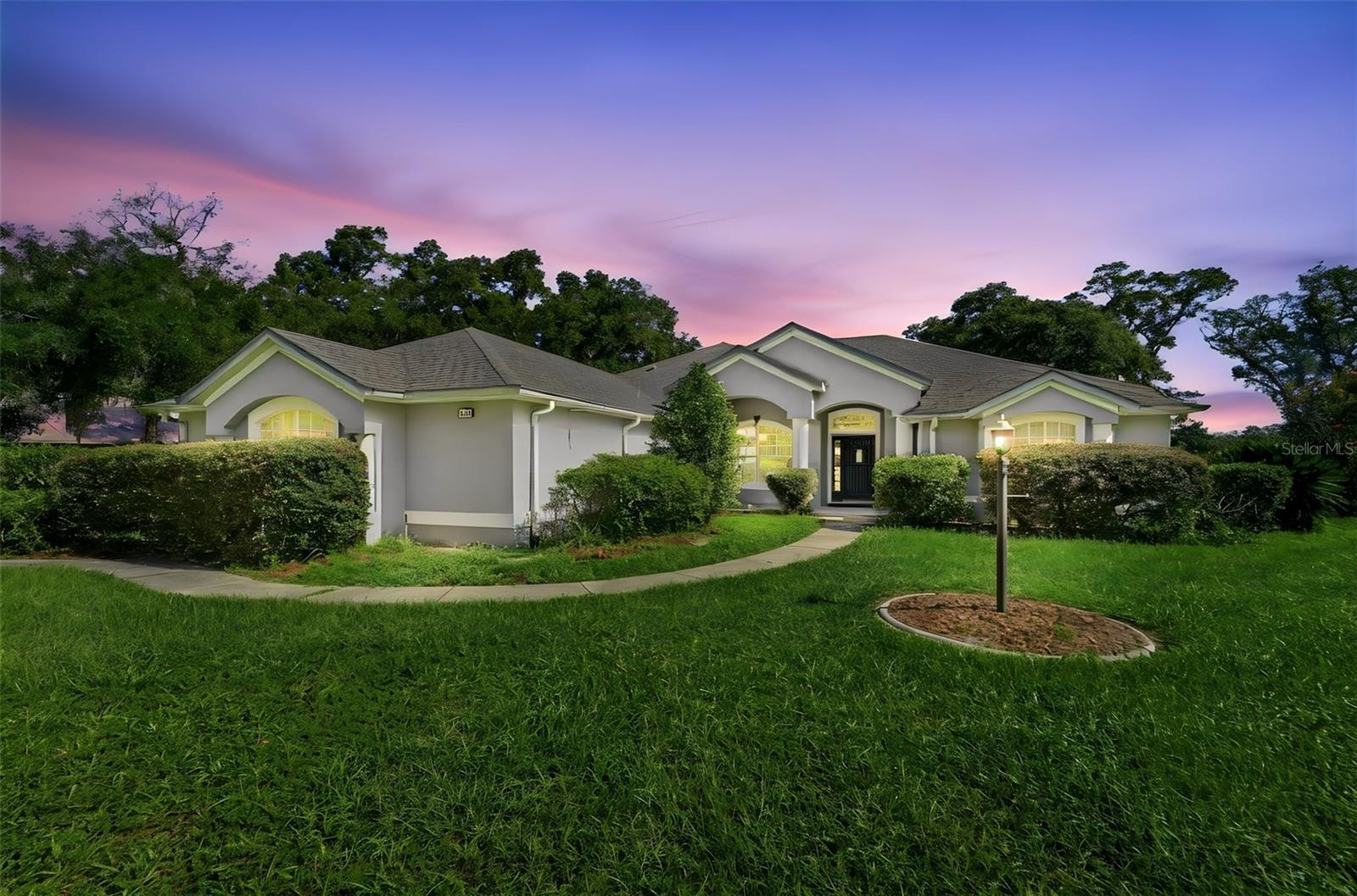 Enjoy the space and privacy of country living without giving up the convenience of being close to town. Located in the highly desirable Mercers Fernery Road area, this well-built home sits on 2.5 acres and is just a short drive to everyday shopping & dining. From the moment you walk through the front door, the open floor plan is easy to appreciate. To the left, the formal living and dining areas provide a comfortable space for spread out while continuing through the home leads you into the spacious kitchen and family room, the true gathering area of the home. The kitchen features beautiful hickory cabinetry with pull-out storage, a large center island, breakfast bar, built-in desk area, and a nice sized pantry. The primary suite is tucked away near the front of the home and offers privacy along with direct access to the screened patio. The en-suite bathroom includes a large vanity with storage, garden tub, separate walk-in shower, private water closet, and an oversized walk-in closet because closet space is never something anyone complains about having too much of. The split-bedroom layout provides three additional bedrooms and two more full bathrooms located off the kitchen area. Multiple sliding doors extend the living space outdoors to the oversized screened-in patio w-jacuzzi tub. An ideal spot for relaxing evenings, weekend gatherings, or enjoying the privacy that comes with having 2.5 acres. Whether you’re creating an outdoor lounge area, a place to entertain, or simply a quiet escape. The home also includes a three-car side-entry garage, interior laundry room with utility sink, built-in storage and shelving, water filtration and treatment system, irrigation system, gutters, hurricane-ready window preparation, and a detached utility building with a generator to help power essential items, lighting, and the mini-split AC system in the third bedroom. With a spacious layout, solid construction, and a great piece of property, this home offers the flexibility buyers are looking for today. Bring your style, your ideas, and a little imagination, this is a home with great potential waiting for its next chapter.