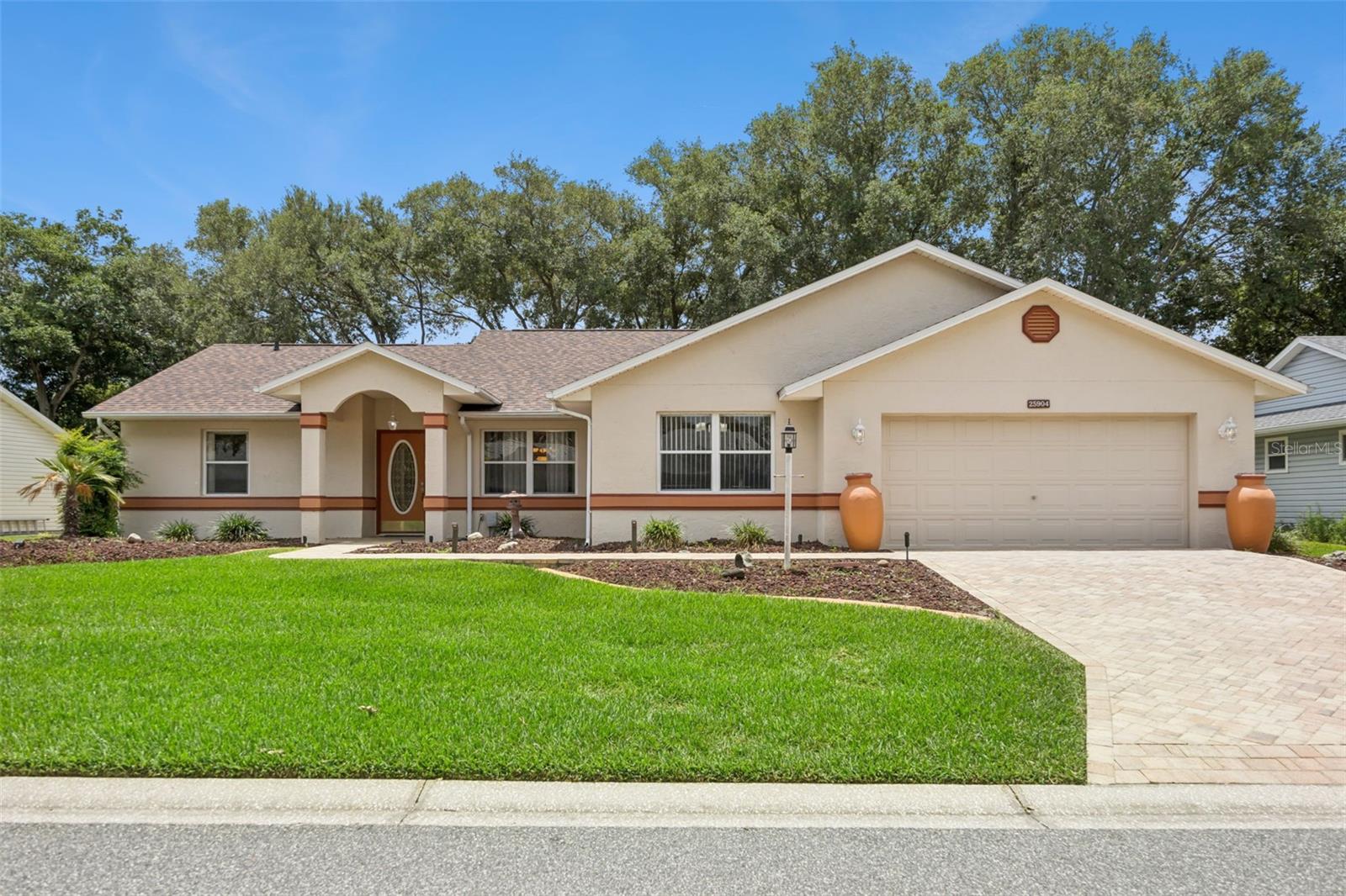 Original owner took great pride in ownership of this well-maintained single-family home. Close proximity to the clubhouse. BLOCK and STUCCO exterior | 3-bedrooms | 2 baths | OVER-SIZED 2 car garage features 610sf of mancave space | MOVE-IN READY! BRICK PAVED DRIVE & WALK | Covered front entry leads to an open floor plan featuring living and dining room combination with decorative molding | Large eat-in kitchen boasts STAINLESS APPLIANCES (NEW dishwasher) and natural gas range, tile flooring. NEW LVP (Luxury Vinyl Plank) flooring | FRESH INTERIOR PAINT | SKYLIGHTS for lots of natural lighting |Family room/bonus room features Shiplap entertainment wall with built-in electric fireplace, wet bar for entertaining, including mini frig and cooktop | Primary Retreat comes with NEW LVP flooring, His & Her walk-in closets, an ensuite bath with wheelchair accessible shower boasting glass block and tile surround, tall vanity with granite top and dual sinks | SPLIT BEDROOM LAYOUT with two additional bedrooms and updated guest bath | Florida Room over-looks peaceful backyard setting | ROOF 2022 | UPDATED SIEMENS electric panel (2026) | WATER HEATER 2016 | newer HVAC

Highland Lakes is a gated 55+ community situated in Central Florida just south of Leesburg & offers residents the following amenities: Recreational Clubhouse with two swimming pools; indoor (heated) & outdoor, a softball field complete with concession stand, an indoor arena with a stage for comm. events, complete kitchen, billiard/ping pong rm., 4 tennis courts (2 courts are lighted), 1 indoor tennis court, 8 lighted shuffle board courts, bocce ball courts, 2 outdoor and 4 indoor pickleball courts, 7 horseshoe pits, covered picnic pavilion with picnic tables & grills to barbeque, library, meeting/card room, exercise room/fitness, craft room, golf driving range, RV/boat storage (included in HOA) & has 260 spaces on a secured lot (fenced & lockable), a Craftsmen building/woodworking shop (homeowners can join the club for only $12 annually and use any/all tools available), there's also a Nature Trail within the community & seven lakes scattered throughout Highland Lakes; 4 are used by residents for catch & release fishing! Don't wait............. call now to schedule your private tour!