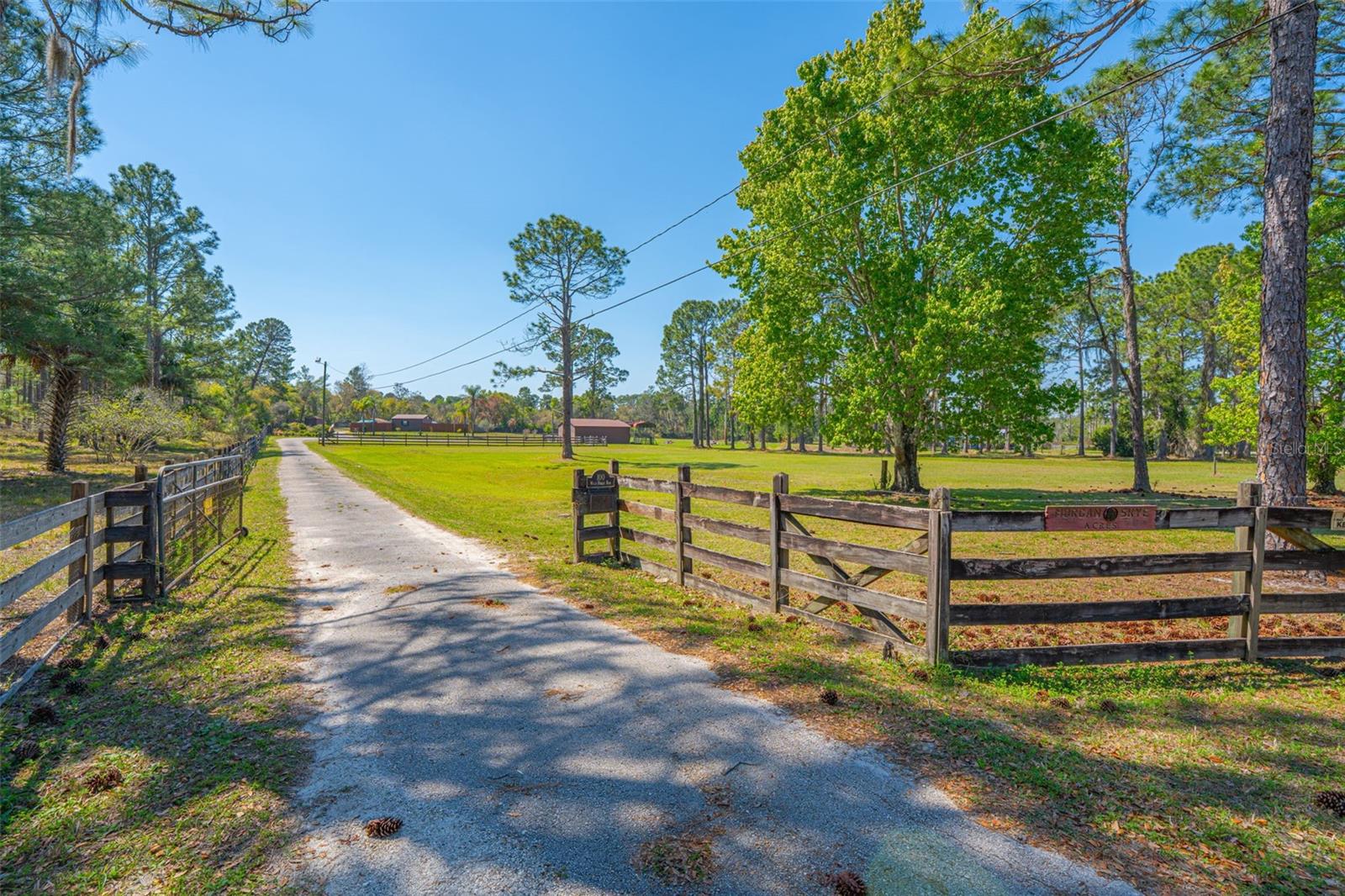 BACK ON MARKET! Discover the perfect opportunity to own 5.01 acres of private, fully fenced and gated land tucked away on a quiet private street in Deltona. This beautifully maintained property offers both space and versatility, ideal for those seeking privacy and room to expand. Additional improvements already in place include a well, updated septic system, and water softener, adding significant value and convenience for future development. This property is equipped with two satellite cable connections, making it ready for modern connectivity while maintaining its peaceful, rural feel. Additional features include a carport and unfinished garage/residential structures, offering endless potential to make this property your own. Providing ample space for storage, workshops, or future customization. The land is cleared, landscaped, and well-maintained, making it ready for immediate use or future plans. Zoned AG-2, this property provides exceptional flexibility, allowing for agricultural use, residential living, and the opportunity to operate certain businesses directly from the property. Whether you're looking to create a private retreat or invest in land with existing infrastructure and income-producing potential, this unique property offers incredible opportunity in a serene setting.