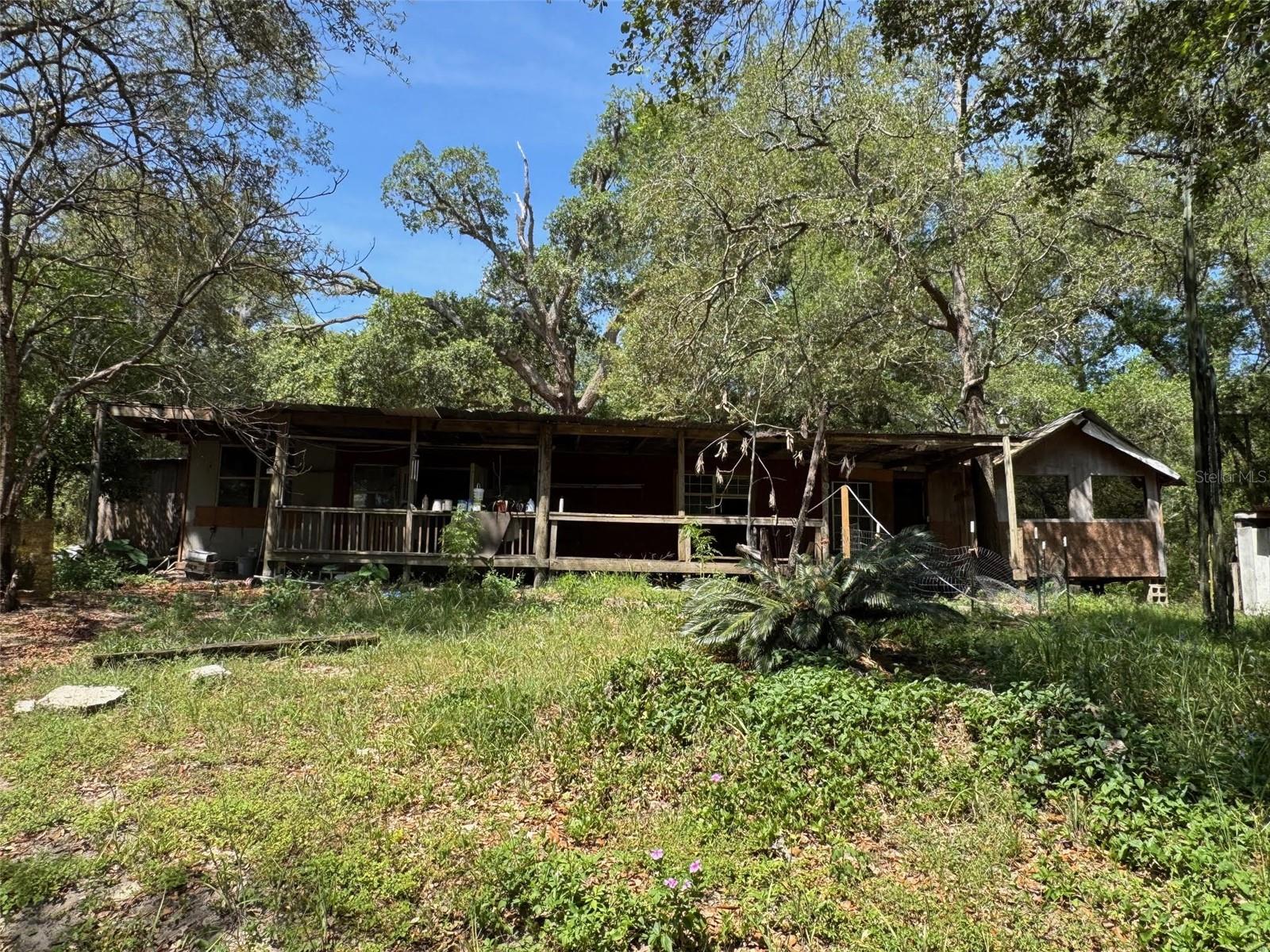 10 acres bordering Next to State property with lots of privacy.  Frame home with electric and well.  Property has lots of potential to be developed for any farm use desired.   Nice sandy roads for lots of horseback riding in the neighborhood.  Silver Springs less than 5 miles away and Lake Weir to the south of the property.