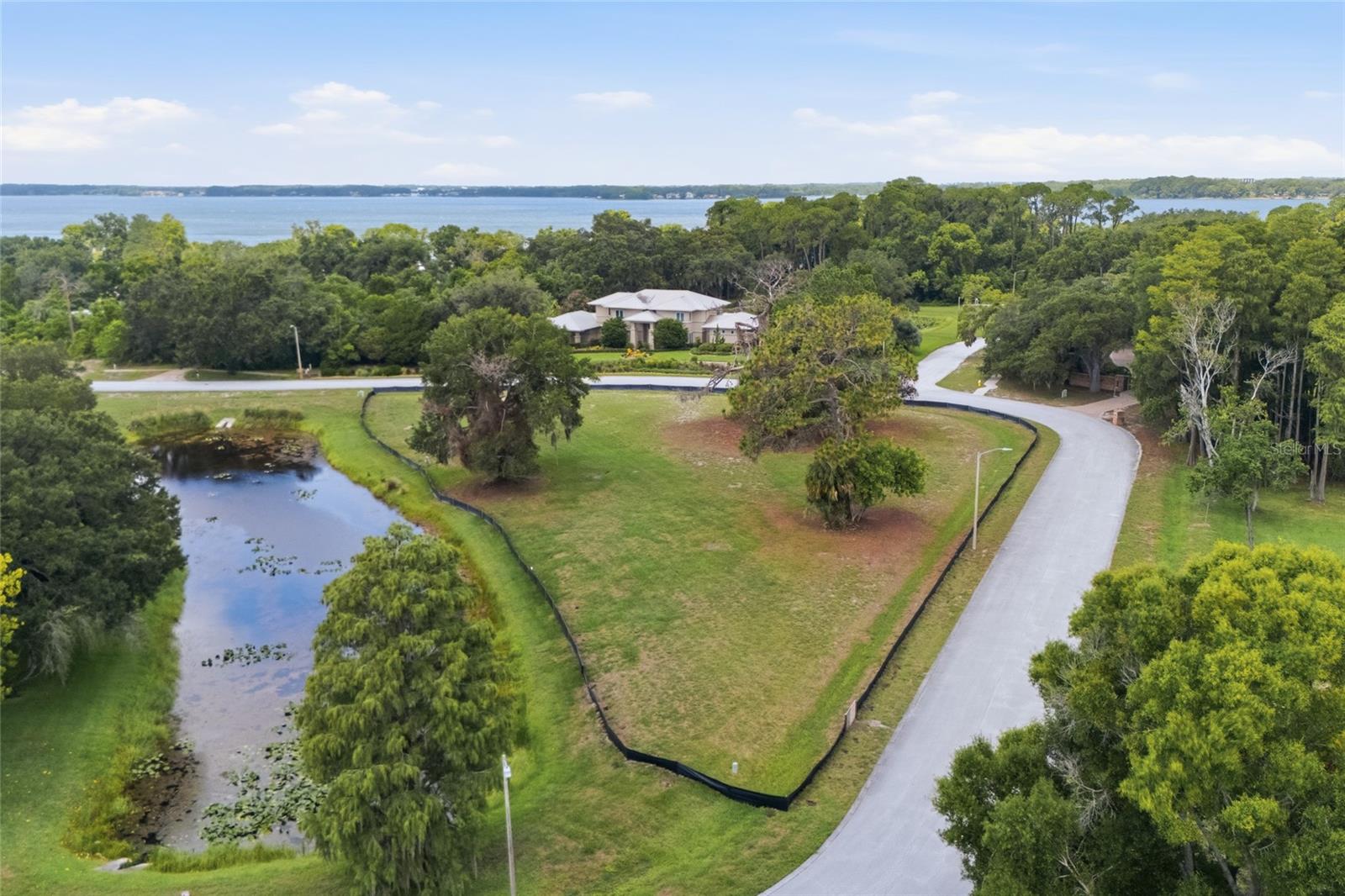 Tarpon Springs. The only remaining vacant lot in the neighborhood, this cleared, ready-to-build property offers an exceptional opportunity to create a custom estate within a private enclave of only 18 distinctive homes. Enter through the community’s gated entrance and enjoy access to the beautiful Lake Tarpon waterfront, featuring a community pier and a dedicated water-access area for boating, fishing, kayaking, paddleboarding, and enjoying the Florida lifestyle. The spacious corner homesite provides added flexibility when designing your custom residence, pool, outdoor entertaining spaces, and landscaping. LakePlace offers low HOA fees and a peaceful, private setting while remaining conveniently located near shopping, dining, golf courses, Gulf Coast beaches, and the historic Tarpon Springs Sponge Docks. This turnkey homesite is a rare opportunity to build your dream home in one of Tarpon Springs’ most desirable lake-access communities