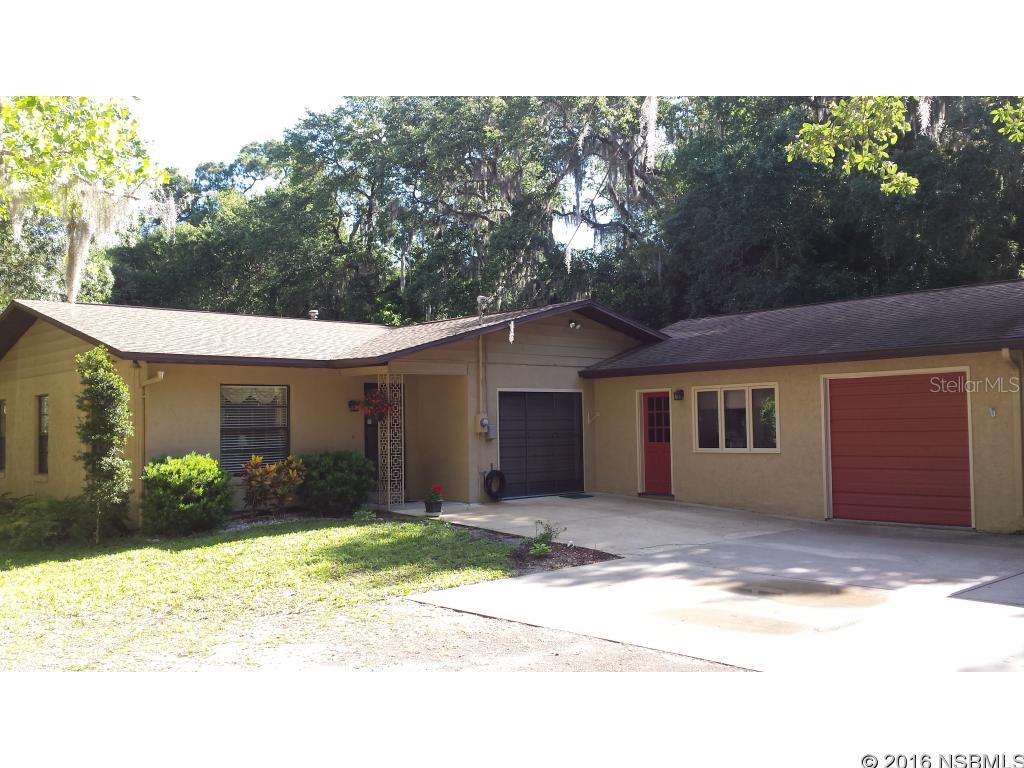 Don't miss the opportunity to own this 3 bedroom 2 bath split floor plan home  on 1.25 acres. The serene setting is the perfect place to entertain friends and family. There's plenty of storage for all your toys and hobbies. It boasts a 700 sq.ft. garage complete with workbench and air compressor which is piped outside under the carport. The 190 sq. ft. shed in the backyard has 50 amp service and the carport which could easily accommodate an RV or other large vehicle is equipped with 30 amp. Country feel with convenient location. Minutes to shopping, I 95, several golf courses and beach. No HOA. A/C installed in 2011 and warrantied until 2021. New roof in 2013. Recently installed gutters and carpet in master bedroom. Seller will consider all serious offers. Remarks: Garage is a 2 car but has only one door. ;Water: City