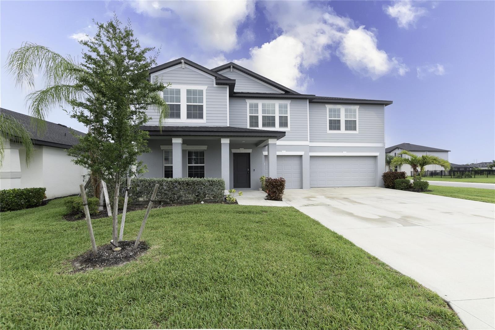 Built in 2023 and tucked inside the gates of Crane Landing, this North Fort Myers home solves the one problem every growing family runs into: space, laid out right. Five bedrooms and three full baths spread across 3,254 square feet give everyone room to breathe, while the primary suite sits on the first level — a rare find that makes this home as practical for aging parents and visiting grandparents as it is for a house full of kids. The three-car garage means no more fighting over parking or hauling gear in from the street, and the 10,890-square-foot lot leaves plenty of room to add a pool, a play set, or simply grass for Sunday afternoons. Life at Crane Landing extends well past the front door: residents enjoy a private dock with lake access, a three-acre fishing pond, more than two miles of scenic trails bordering the Yellow Fever Creek Preserve, a playground, and sports courts for basketball, soccer, pickleball, and tennis, ALL inside a gated, master-planned community minutes from downtown Fort Myers and Cape Coral. This is a floor plan built for the way families actually live now together, but with room to close a door when you need to. Homes with true single-level primary suites, this much square footage, and this amenity package don't sit on the market in North Fort Myers; call today to schedule your private tour.