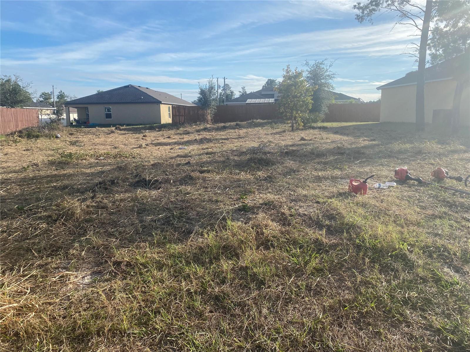 Build your future on one of Central Florida's most strategically located lots — cleared, surveyed, and ready to go! This 7,998 sq ft lot (0.18 acres) sits in Poinciana Neighborhood 2, Village 8, zoned PUD, with 75 feet of front footage — giving you a wider, more buildable footprint than most lots in the area. Located in Flood Zone X, meaning no flood insurance required. Public water is available, survey is complete, and the lot is already cleaned up. Just bring your builder.
Poinciana is one of the fastest-growing corridors in Central Florida, spanning Polk and Osceola counties, and the growth story here is real. Poinciana Parkway provides direct, high-speed access to Kissimmee, US-192, and the greater Orlando metro. The SunRail Poinciana Station brings commuter rail access right to the community — a major infrastructure investment that continues to drive property values upward. The Florida Turnpike and US-17/92 are minutes away, connecting you to all of Central Florida with ease.
Entertainment and recreation are right at your doorstep. Walt Disney World, Universal Studios, and LEGOLAND Florida are all within a short drive. The Walt Disney Wilderness Preserve offers nature lovers thousands of acres to explore. Everyday conveniences including major retailers, restaurants, and medical facilities are all nearby and growing fast as Poinciana continues to expand.
Community amenities through the Association of Poinciana Villages include pools, sports courts, parks, playgrounds, the APV Activity Center, and the Mary Jane Arrington Gym & Aquatic Center — all for just $300/year HOA. Lot dimensions: 75x103x75x107. Fee Simple ownership. Priced to move — opportunities like this don't last.
