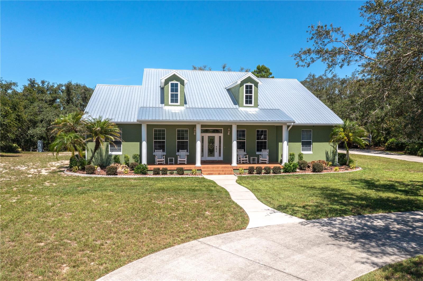 WOW!! THAT'S WHAT YOU WILL SAY WHEN YOU STEP INSIDE THIS CUSTOM-BUILT HOME. UNIQUE HIGH END FINISHES THROUGHOUT. 3 bedrooms, 2 bathrooms, 2 car attached garage, screened lanai on the back and all of this on 3.23 acres of land!  Brand new metal roof in June 2026. Freshly painted exterior in 2026. Real wood floors, 2 walk-in pantries, 2 huge walk-in closets in primary suite. Split bedrooms, open floor plan, beautiful fireplace, inside laundry, storage room off of garage, 2-car carport for your boat, or anything else you want to put there. Circular driveway.  This home is in a rural area but very close to everything you need or want, such as restaurants, medical facilities, gyms, churches, shopping, and most importantly, a short drive to Orlando or Tampa attractions, and Atlantic and Gulf beaches.  Lots of lakes in this area if you enjoy boating or fishing. There is no way to comprehend or imagine the beauty and convenience of this property without seeing it. Don't let this one get away!! Make an appointment to see it now! This may be the only opportunity you get to own a home and property of this caliber for this price!  IT'S AMAZING AND STUNNING!!
