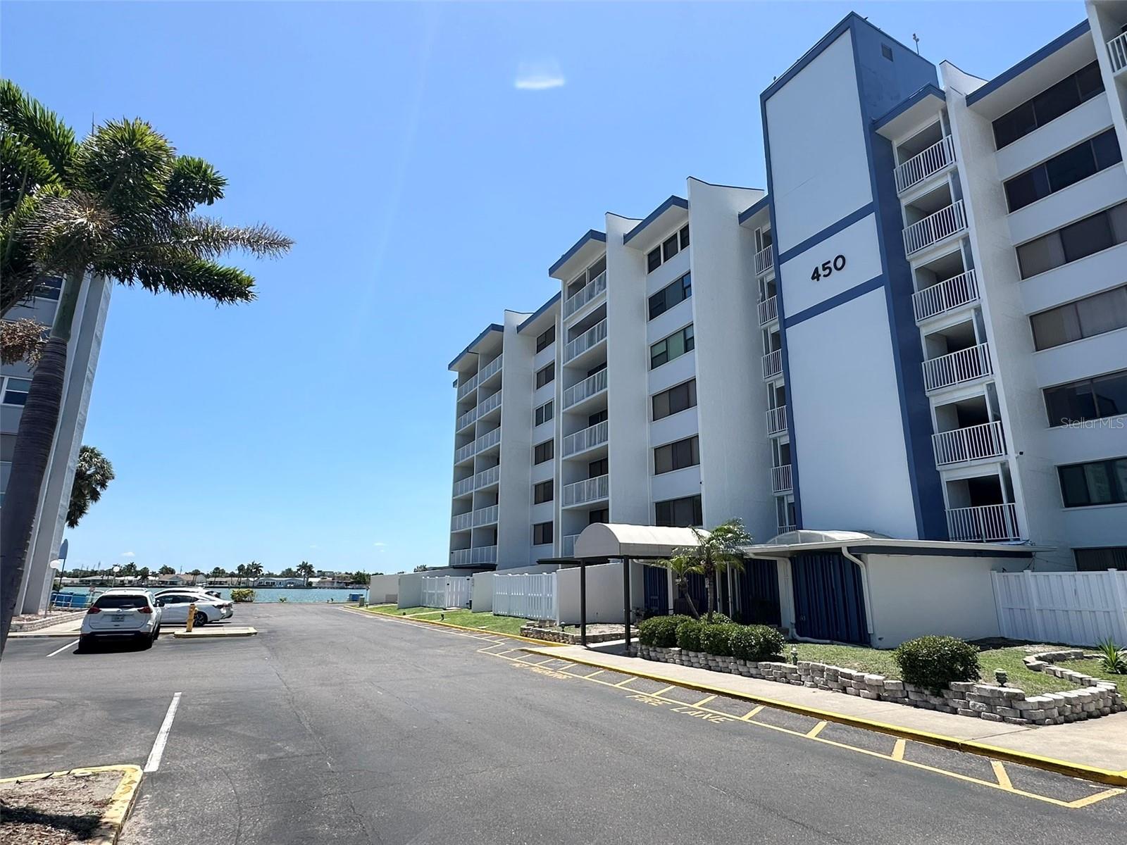WATERFRONT UNIT with breathtaking water views from every room! Perfectly positioned within the desirable Treasure Island community, this exceptional residence captures stunning south waterfront vistas, providing a front-row seat to dolphin sightings, luxury yachts cruising through the channel, and sparkling open-water scenery all without the harsh afternoon sun. Designed for effortless Florida living, the open-concept floor plan seamlessly connects the spacious great room, dining area, and kitchen, creating an ideal setting for entertaining or simply relaxing while enjoying captivating water views day and night. The sizable kitchen offers abundant cabinetry and workspace, while durable carpeting and a convenient guest half bath add comfort and functionality. The primary suite serves as a peaceful waterfront retreat, featuring incredible water views and an ensuite bath with a separate vanity area, private water closet, and tub/shower combination. Tropical-inspired wallpaper adds character and charm to the spacious main bedroom. Additional features include hurricane-rated impact windows and sliders, expansive four-panel sliding glass doors with screens that allow you to enjoy refreshing waterfront breezes year-round, and the convenience of an in-unit washer and dryer. Step onto your private balcony and enjoy some of Treasure Island's most beloved traditions, including spectacular Fourth of July fireworks and the famous Lighted Boat Parade passing directly by your unit. Additional conveniences include an assigned parking space, elevator access, and secure, low-maintenance condo living. Ideally located just minutes from downtown St. Petersburg's vibrant dining, shopping, museums, art galleries, waterfront parks, and festivals. Treasure Island Beach is only a short walk, bike ride, or golf cart ride away, along with iconic Sunset Beach, where you'll experience some of Florida's most spectacular sunsets.