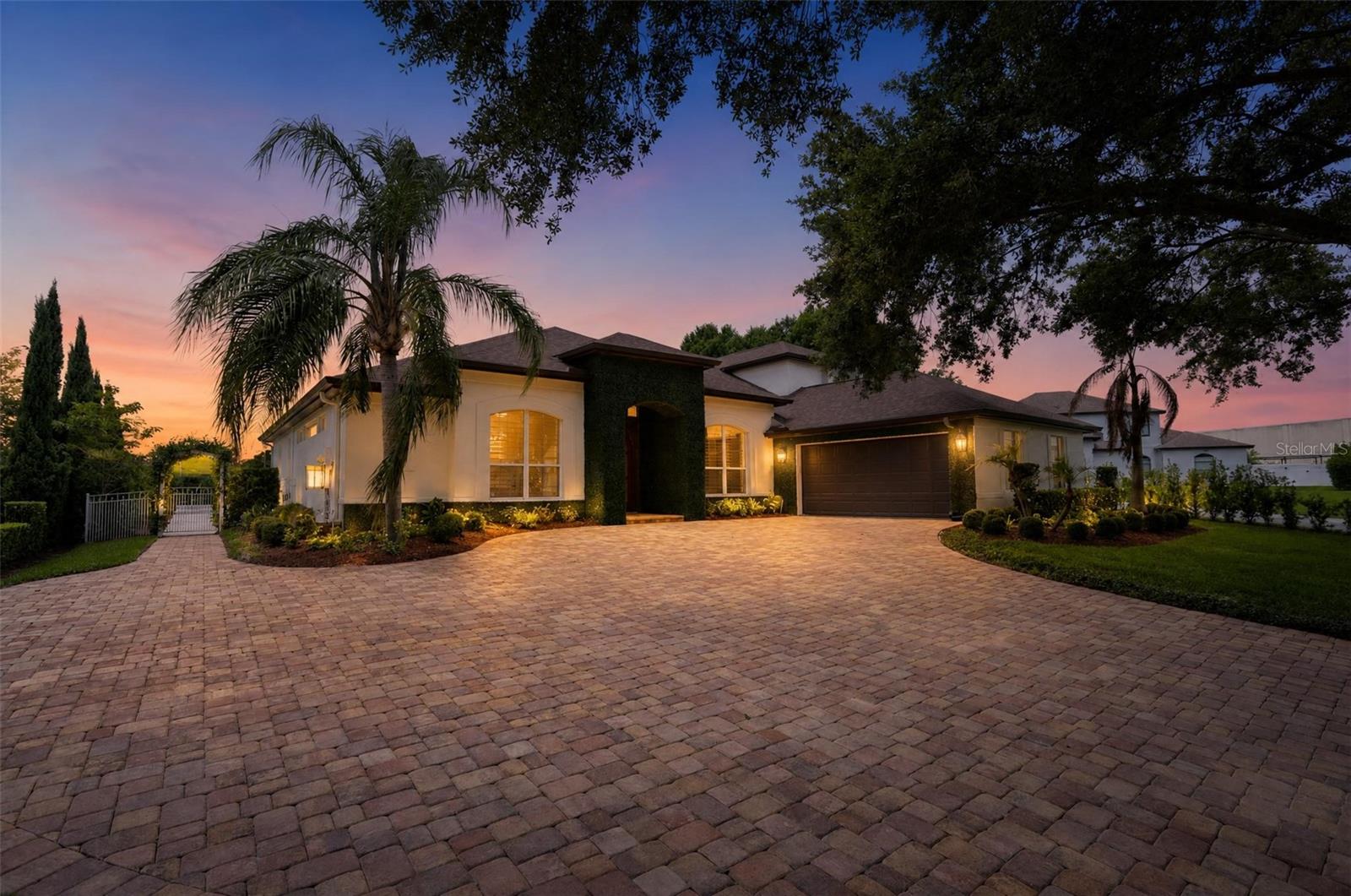Surrounded by lush landscaping & positioned on an oversized cul-de-sac lot in the Westminster Landing gated community this luxurious residence makes a striking first impression. Beyond custom arched entry doors grand foyer welcomes guests with soaring ceilings designer lighting herringbone porcelain flooring custom plantation shutters & curated designer finishes. Formal dining room offers custom moldings & a dazzling crystal chandelier. Formal living room provides a refined gathering space with fireplace. Primary suite is designed for comfort & relaxation featuring rich hardwood flooring elegant crown molding custom plantation shutters & a built-in window shelving unit offering abundant natural light. Beautifully remodeled primary bath showcases designer finishes & spa-inspired elegance including a freestanding tub custom vanities with vessel sinks porcelain tile flooring & a stunning glass shower. Primary suite includes 2 closets a linen closet & a home office originally designed as a first-floor bedroom & converted into a secure home office accessible only through primary suite; it can be restored to 6th bedroom. Split-bedroom floor plan places primary suite in its own private wing while three secondary bedrooms & two remodeled bathrooms are on opposite side of home. Upstairs second level provides a fifth bedroom, bathroom, linen closet, bonus room & game room, creating an ideal retreat. Kitchen is a true showpiece blending exceptional craftsmanship top-of-the-line appliances & bespoke finishes including custom cabinetry 24-karat gold-plated cabinet pulls marble countertops oversized island built-in Samsung Refrigerator Thermador dishwasher KitchenAid trash compactor reverse-osmosis water filtration system & butler’s pantry. ILVE Majestic II 60-inch dual-fuel range serves as centerpiece beneath a custom brass range hood equipped with a Vent-A-Hood Pro Series ventilation system. Built-in breakfast nook framed by a bay window overlooks Florida Room built in 2023 with designer wall & ceiling finishes & motorized smart screen system. Renovation transformed yard into a private resort-style retreat including resurfacing & retiling pool & spa adding a pool heating system marble decking & extending patio to create an exceptional outdoor living & entertaining space with dining terrace, 2022 Catalina Luxury Carlton hot tub smart café lighting controlled by a dedicated wall switch & more. Podocarpus hedges provide a privacy fence throughout property. Charming garden arbor & picket fence lined with Star Jasmine lead to a lush backyard oasis shaded by a majestic oak tree. Additional exterior upgrades include extended and newly paved driveway whole-house water-softening system new roof smart keyless entry on exterior doors video surveillance system invisible dog fence & MyQ LiftMaster smart system in two-car garage, and a charming paver pathway on the side of the house leading to the backyard through a garden arbor draped in fragrant Star Jasmine Ivy, creating a welcoming transition to the outdoor living spaces beyond. Buyer will be provided with a one-year home warranty covering heating & air conditioning electrical plumbing systems kitchen appliances & more. This exceptional home is shown only to qualified buyers.