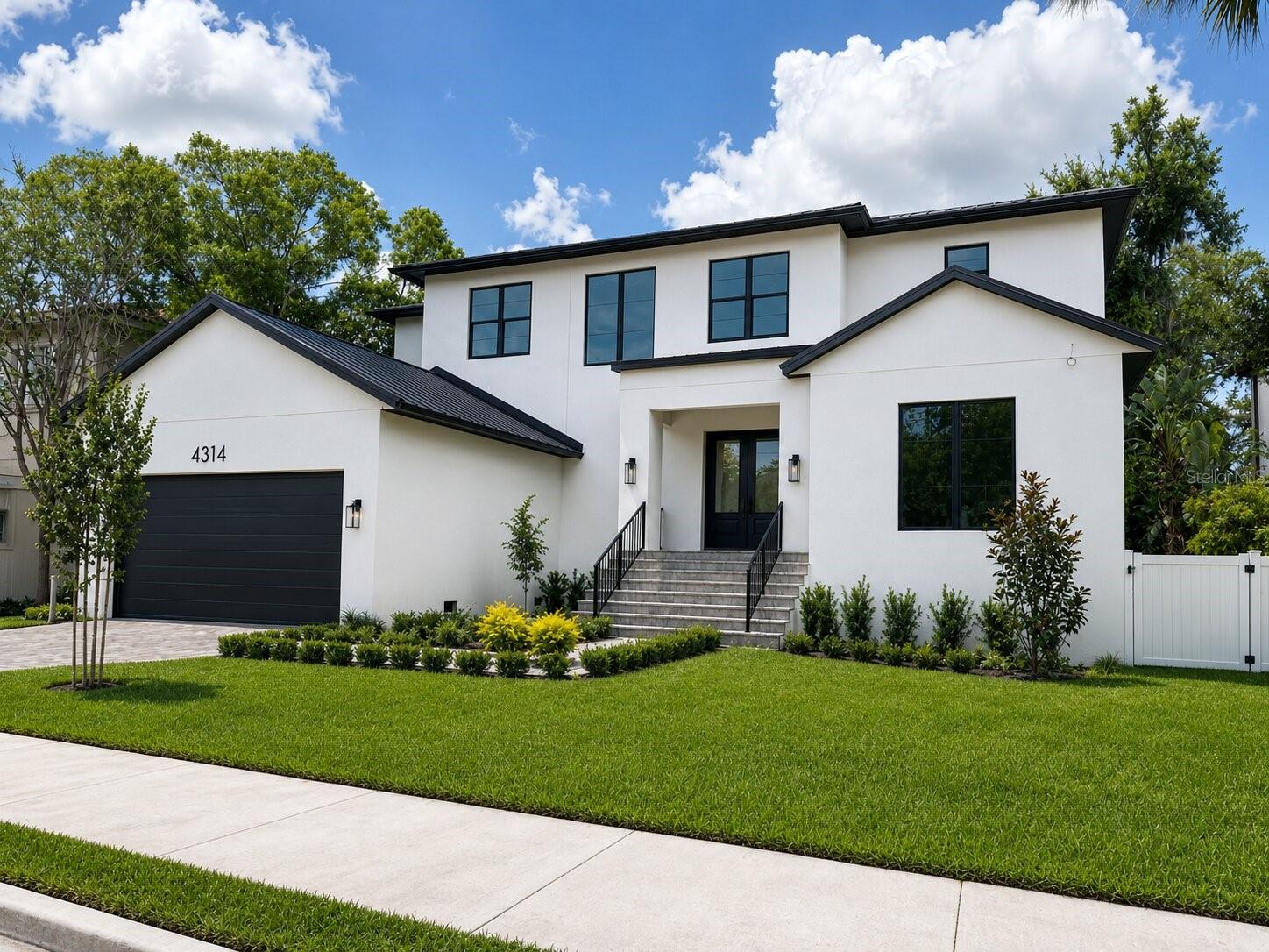 One or more photo(s) has been virtually staged. Under Construction. Perfectly blending timeless Spanish Contemporary architecture with modern luxury, this exceptional new construction residence in the heart of South Tampa is nearing completion and will be ready to move in soon! Offering more than 4,400 square feet of thoughtfully designed living space, the home features five bedrooms, five full bathrooms, one half bath, and an oversized tandem garage with room for a third vehicle.
Designed for both everyday comfort and elevated entertaining, the first floor showcases an open, airy layout centered around a grand welcoming foyer that includes a custom built-in bench with storage. A private office/study provides an ideal work-from-home retreat, while the versatile guest suite (with full bath that can function as a pool bath in the future) can easily function as an additional bedroom, media room, fitness space, lounge, or flex room tailored to your lifestyle. At the heart of the home, the expansive great room is highlighted by two arches that create a spectacular visual impression like nothing else, a dining area, and chef’s kitchen seamlessly connect to create an inviting atmosphere for hosting gatherings large or small. The designer kitchen is appointed with gourmet appliances, custom solid wood cabinetry, a walk-in pantry with custom cabinets, shelving and decorative tile backsplash, contemporary lighting, a decorative wood vent hood flanked by floating shelves, expansive island, and a spacious walk-in pantry with custom wood shelving, powder room. Just off the kitchen is the mudroom that offers ease of access to the garage and functions as a storage space for shoes, jackets, backpacks, sports equipment and the like. A perfect place to stage what everyone needs for the day.
Upstairs, the luxurious primary suite, which includes walnut cabinetry and tile walls in the primary bathroom is joined by three generously sized bedrooms…all bedrooms en-suite bathrooms, beautiful wood floors, and feature built-in custom closets and drawers. Rounding out the upstairs is a large laundry room and an additional loft/flex space with built-in desk ideal for a secondary office, playroom, study area, or quiet retreat.
Located within the highly sought-after Plant High School district, including Plant High School, Coleman Middle School, and Dale Mabry Elementary School, this prime South Tampa location offers exceptional convenience to Downtown Tampa, Bayshore Boulevard, Hyde Park, Tampa International Airport, premier dining, shopping, entertainment, sporting venues, and the bay bridges leading to the Gulf beaches. Note that images are virtually staged with furniture, decorations, landscaping and features that may or may not be included in the final product.