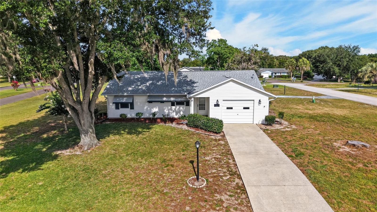Welcome to the 55+ HOA Community of SCOTTISH HIGHLANDS, a GOLF-CART FRIENDLY COMMUNITY with Great AMENITIES!! ** This Adorable Home has Two Bedrooms and Two Bathrooms with a Florida Room/Enclosed Rear Lanai with Glass Slider Windows, Tile Flooring and Heat/Air from the Main Unit – ** Roof 2023 ** Gas Water Heater 11/2011 ** HVAC with Gas Furnace 11/2022 ** -- GREAT LOCATION on a Corner Lot ACROSS THE STREET from the Community Clubhouse & Community Pool!! -- TILE FLOORING Through-out – NO CARPET!! – GRANITE KITCHEN COUNTER TOPS with Tile Backsplash – Ceiling Fans – Updated Light Fixtures – Vaulted Ceiling in the Living Area! – Coat Closet, Walk-in Closet, Pantry Cabinets in Kitchen – Beautiful Bathrooms with Updated Vanity Tops, Medicine Cabinets, Windows, Exhaust Fans & Grab Bars – Move-in Ready, Clean and Well Maintained!! – *** Scottish Highlands has an INDOOR POOL, AND OUTDOOR POOL, Club House, Tennis, Pickleball, Shuffleboard, Bocce Courts, and many more activities to enjoy along with being Golf-Cart Friendly!! ** Don’t miss out on this GEM OF A HOME! !! *** Make sure to watch our attached WALK-THROUGH VIDEO TOUR of this GREAT HOME!!
