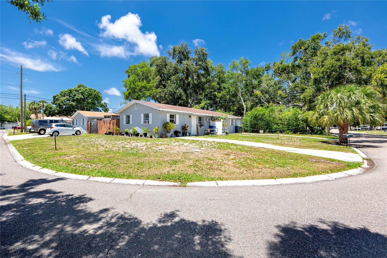 A fully income-producing quadruplex in Largo with documented cash flow, long-term tenants in place, and one vacant unit freshly prepared for immediate occupancy. Two concrete block duplexes sit on a corner lot — eight bedrooms and four bathrooms across four two-bedroom, one-bath units, each with its own laundry and private fenced backyard.
The numbers are straightforward: $79,920 in annual gross income, $69,381 net, with tenants covering electric and water on separate meters. Three units are leased annually; the fourth has been freshly painted, fitted with a new refrigerator, and is ready to go. Updated bathrooms across all four units reflect consistent upkeep rather than deferred maintenance. Two units have private driveways; the other two share a four-car lot with on-street guest parking available.
Block and stucco construction, Flood Zone X with no flood insurance required, and no HOA keep carrying costs predictable. Morton Plant Hospital, Belleair Beach, and St. Pete-Clearwater Airport are all within a short drive — a location that supports reliable long-term tenant demand in the Pinellas County rental market.