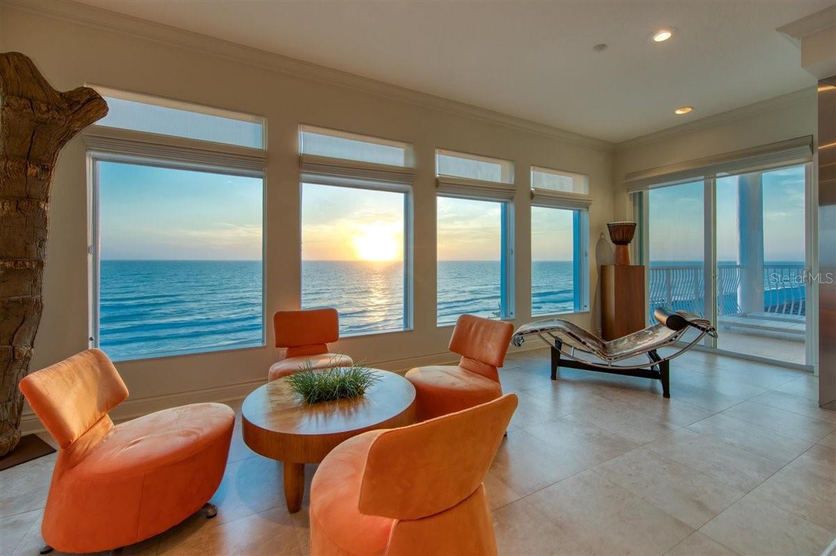 Natural materials and textures, and bold, clean lines work in perfect harmony with stunning panoramic views of The Gulf of Mexico. Occupying the entire floor, this spacious, contemporary condominium embraces modern luxury with a coastal punch. Take the elevator to your private floor where you will immediately feel the comfort created by the sleek, open concept design. The welcoming foyer opens to a grand living room featuring a magnificent floor to ceiling concrete fireplace with lighted glass panels and mural like picture windows gazing out to unobstructed Gulf views. The custom kitchen, a chef’s dream, is both functional and beautiful with concrete countertops and backsplash, mahogany and stainless steel cabinets, and top-of-the-line appliances, including a Thermador coffee system, GE Monogram oven and warming drawer, Bosch dishwasher, and SubZero refrigerator. Many of the kitchen drawers include customized features such as a spice rack, knife drawer, pull out pantry drawers, while the peekaboo backsplash windows offer water views and enhanced natural lighting. Enjoy a quick meal at the breakfast bar or a more formal meal in the perfectly sized dining room. A spacious, separate media room flows effortlessly from the kitchen and has custom built-in cabinetry with a hidden wet bar and mini refrigerator. In addition, you will enjoy a custom audio video system throughout the house. Each bedroom has fantastic views and spacious California Closets. The master bedroom suite has two walk in closets, a private balcony overlooking the Gulf and an elegant bathroom with concrete countertops, glass framed shower, and soaking tub. After touring this home, you won’t be surprised to know that it has been featured in several magazines including House Trends Tampa Bay, Florida Design, and DuPont Registry Tampa Bay. Whether you prefer the early morning calm of a sunrise, or the relaxing glow of an evening sunset, the views from this condo will not disappoint!