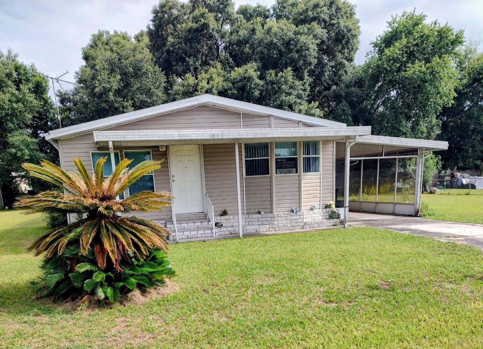 Tired of renting? Could you be thinking of finding a lovely home in quiet area with an exceptionally spacious lot? Maybe you would enjoy having a garden of vegetables or flowers.  This delightful home is super nice and very lovely for singles, couples, or a small family.  The existing furniture is lovely also, in almost new condition,  but if buyer prefers, it can be removed prior to closing.  Polk City is a convenient area for workers at Disney or attractions, close to Auburndale and Lakeland also. Large screened area includes enough room to park a car, plus has a nice sized utility room with washer and dryer connections and shelving.  Rear yard has a metal utility shed, and current fencing is partial around the large lot size.  The lot size is more than 1/4 ac, but less than 1/3 ac.  Make sure you do not miss out on this fantastic opportunity to own such a lovely home at a super price.