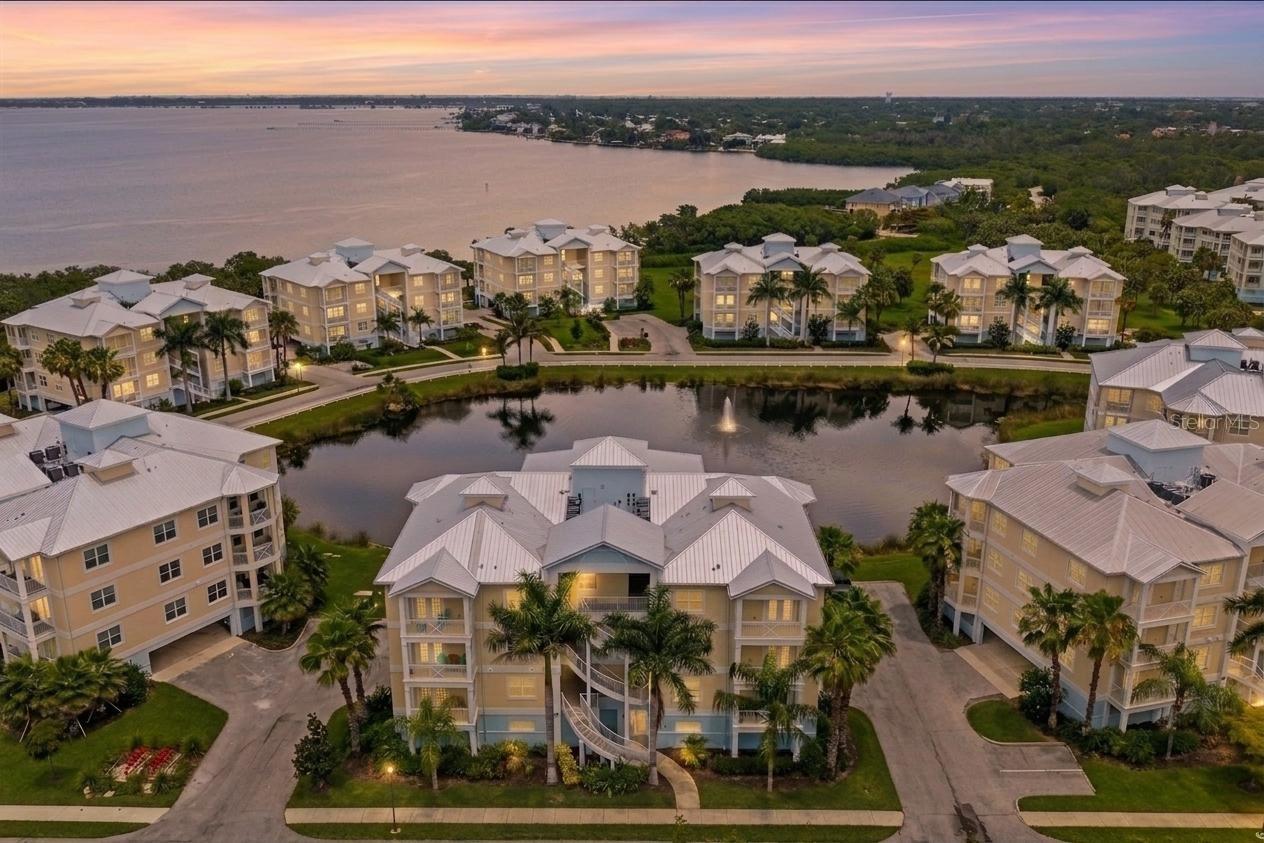 Welcome to resort-style living at its finest in this beautifully appointed two-bedroom, two-full-bath condo nestled within sought-after gated waterfront community with breathtaking views of Palma Sola Bay. Whether you are looking for an amazing year-round home, an investment property, or the perfect vacation getaway with great views, this versatile residence truly has it all. From the moment you arrive, the lush tropical landscaping, manicured grounds, and serene pond with a fountain set the tone for an elevated lifestyle.
Step inside to a bright, open-concept layout bathed in natural light from an abundance of oversized windows. The expansive great room flows effortlessly into the chef-inspired kitchen, featuring premium gray shaker cabinetry, striking granite countertops, a large island with bar seating, stainless steel appliances, and elegant pendant lighting, perfect for entertaining or quiet evenings in. The primary suite is a true retreat, offering generous square footage, plush carpeting, multiple windows framing peaceful community views, and a spa-quality en suite bath complete with dual vanities, granite counters, a walk-in glass shower with a ceiling-mount rain head, a luxurious soaking tub, and designer tile throughout. The spacious second bedroom is equally well-appointed with its own walk-in closet and easy access to the second full bath. Additional highlights include a dedicated laundry room with a full-size Samsung washer and dryer, upper cabinetry, and a utility sink, a rare and coveted feature.
The community itself offers unparalleled resort-style amenities, including a sparkling pool, a cozy fire pit, a billiards room, barbecue areas, and tranquil lakeside grounds. Water enthusiasts will love the convenient on-site boat and kayak launch, providing seamless access to stunning Palma Sola Bay. Perfectly situated for both leisure and convenience, this exceptional property is located just moments from the pristine beaches of Anna Maria Island, the world-renowned IMG Academy, top-rated dining, and the very best of Florida's Gulf Coast lifestyle. With its unbeatable combination of location, luxury, and versatility, this is an incredible opportunity you don't want to miss. Is this home your perfect match?