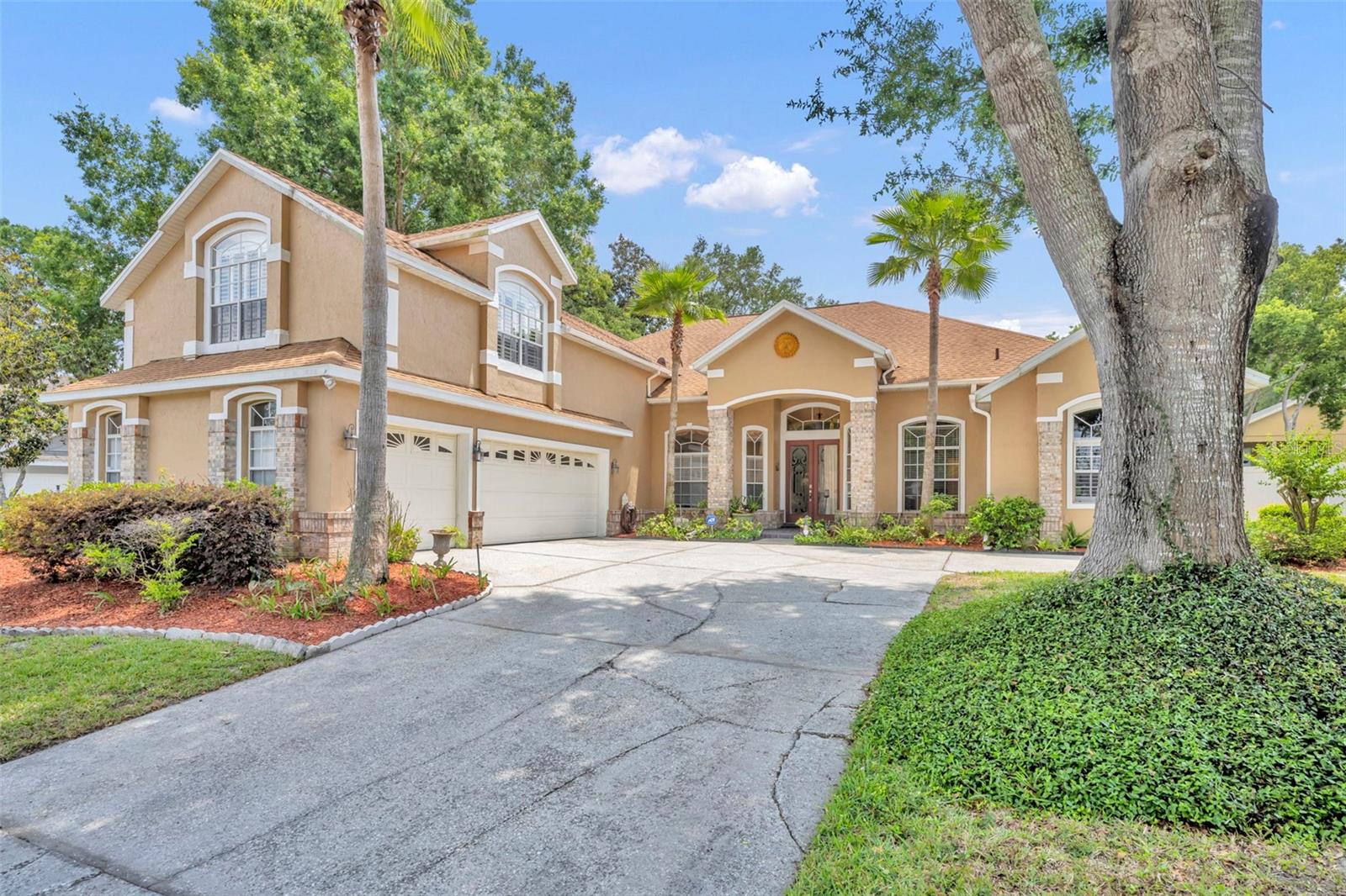 With undeniable curb appeal, this exquisite 3444 sq.ft. 5 bedroom 4 bath home in Sweetwater Country Club embodies timeless elegance and effortless Florida living.  Roof is 4 years old and A/C is 3 years old. A grand double door entry opens to a welcoming foyer, immediately revealing serene views of the sparkling pool and living spaces. Designed for both refined entertaining and relaxed everyday living, this home features an inviting outdoor oasis complete with pool and solar heated spa, along with fully appointed outdoor kitchen.  Inside, the formal living room impresses with soaring ceilings, crown molding and triple disappearing sliding glass doors that seamlessly connect to the lanai-blurring the line between indoor and outdoor living.  A gracious formal dining room highlighted by distinctive coffered celiing sets the stage for unforgettable gatherings.  At the heart of the home, the expansive chefs kitchen showcases 42"  wood cabinetry, granite counters, tile backsplash and stainless steel appliances which include a double oven and glass cooktop. The adjacent family room is anchored by a cozy wood burning fireplace offering a warm and welcoming retreat.  The luxurious primary suite is a private sanctuary featuring a spacious sitting area and dual walk in closets.  The spa inspired en suite bath pampers with dual vanities, a deep soaking garden tub and a separate glass enclosed shower.  3 additional generously sized bedrooms are thoughtfully situated on the main level, while a versatile bonus room or 5th bedroom ensuite is on the 2nd floor, perfect for guests.  This exceptional residence presents a rare opportunity to enjoy elegant living in one of the areas most sought communities.  Residents of this desireable community also enjoy access to Lake Brantley, featuring a private boat ramp, beach, pavillion, beach volleyball court and playground.  Convenient to Wekiva Springs State Park, a  unique 7,000 acre natural retreat known for beautiful springs and beautiful walking trails.