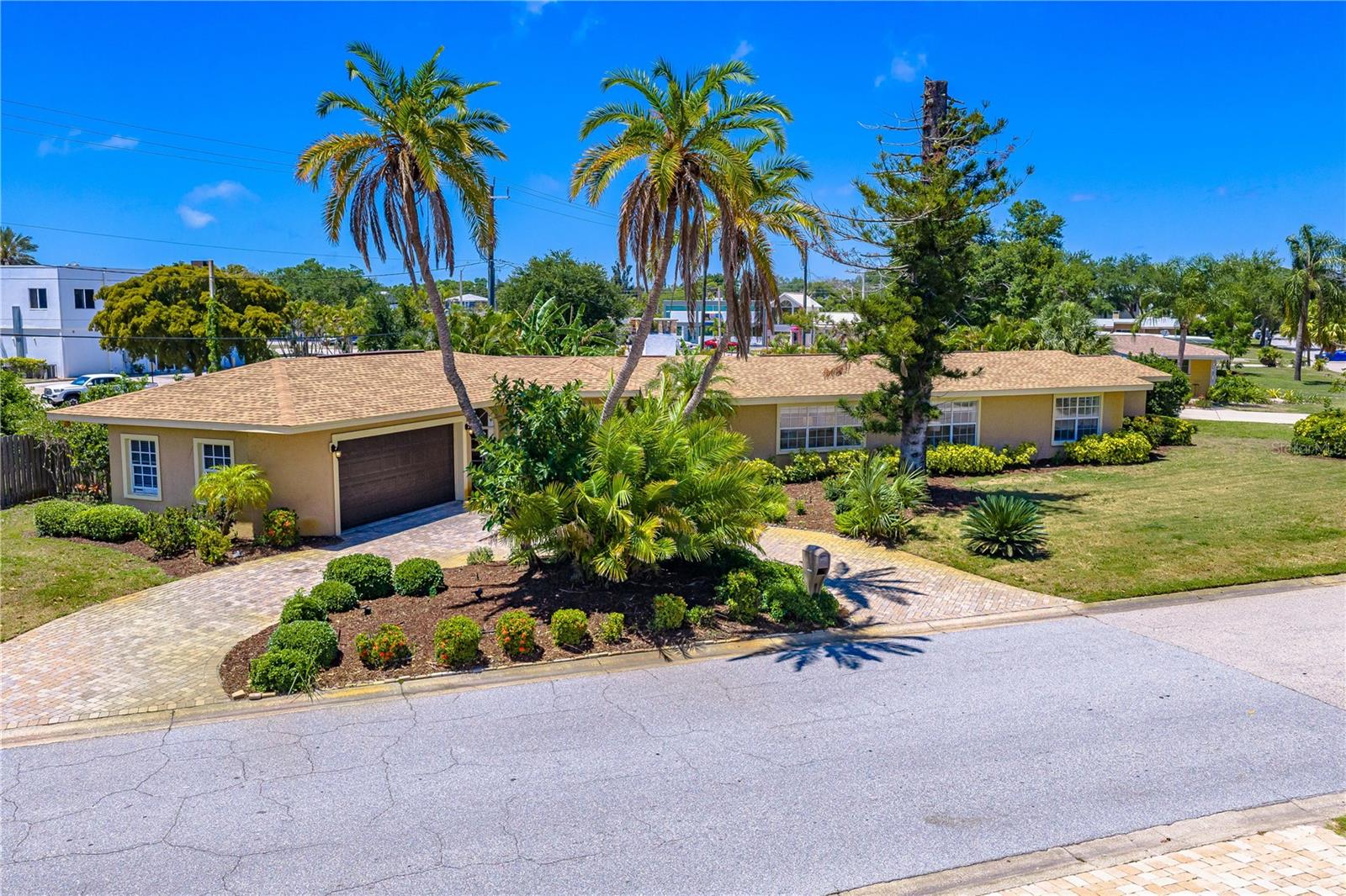 From the moment you arrive, you’ll fall in love with the charm, warmth, and unbeatable location of this tropical Mediterranean retreat in Sarasota’s highly desirable South Gate neighborhood, located within the coveted Southside School District. Perfectly situated in the heart of it all, this home places you just minutes from the world-renowned Siesta Key Beach while also being steps away from your favorite restaurants, boutique shopping, grocery stores, gyms, movie theater, and everyday conveniences. This is the rare opportunity to enjoy a true walkable lifestyle while still having the privacy and comfort of a spacious family home. Light-filled and inviting, this beautifully maintained single-story residence offers an open and airy floor plan designed for both relaxing and entertaining. With four spacious bedrooms, two remodeled bathrooms, multiple living and dining areas, a breakfast nook, sunroom, and dedicated home theater room, there is space for everyone to gather while still enjoying privacy and comfort. Large sliding glass doors, solar tubes, and gorgeous porcelain marble-look flooring fill the home with natural light and create a bright, welcoming atmosphere throughout. Step outside and discover your own private backyard paradise. The newly added heated pool with paver deck, lush tropical landscaping, fenced yard, and multiple entertaining spaces create the perfect setting for enjoying Florida living year-round. Whether you’re unwinding by the electric fireplace, soaking in the jetted tub, hosting friends and family, or biking to Siesta Key for sunset, this home offers the lifestyle buyers dream about. Thoughtful updates include a 2022 roof, newer flooring throughout, updated bathrooms, and a new water heater. The oversized two-car garage with space for a workshop, spacious laundry room, circular paver driveway, and sprinkler system on well water add both convenience and value. Currently operating as a successful vacation rental with weekly rentals allowed within city limits, the property also presents exceptional income-producing potential or flexibility for a future in-law suite. Offering one of the lowest costs per square foot in South Gate, this exceptional property combines location, lifestyle, and versatility in one unforgettable home buyers will instantly fall in love with.