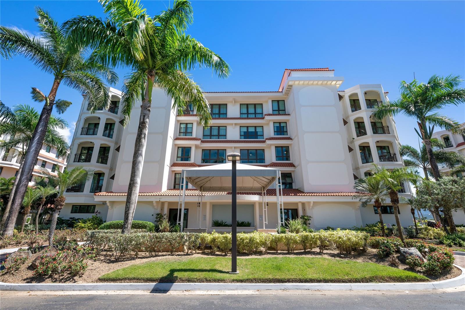Experience resort-style island living in this beautiful contemporary third-floor apartment located within the private golf village of Country Club Residences at Grand Reserve Resort, offering panoramic views of the lush rainforest, surrounding mountains, and eastern water vistas. Replete with high-end finishes, this modern open concept 4 bedroom, 3.5 bathrooms residence seamlessly blends the natural seascape with a bright and airy interior.

The property showcases a spacious living and dining area that flows effortlessly to a private terrace, ideal for enjoying serene mornings or peaceful evenings surrounded by lush greenery. The kitchen has been thoughtfully remodeled and features ample cabinetry and functional workspace, making it perfect for entertaining or preparing quiet meals at home. Generous bedrooms provide a tranquil retreat, with the primary suite offering privacy, comfort, and a true resort-style ambiance.

Located within a gated golf community known for its manicured landscapes and upscale amenities, residents enjoy access to scenic surroundings, championship golf courses, and a lifestyle centered around leisure and relaxation. Whether you are seeking a primary residence, vacation getaway, or investment opportunity, 302B at Country Club Residences presents a rare opportunity to own in one of Río Grande’s most desirable communities.