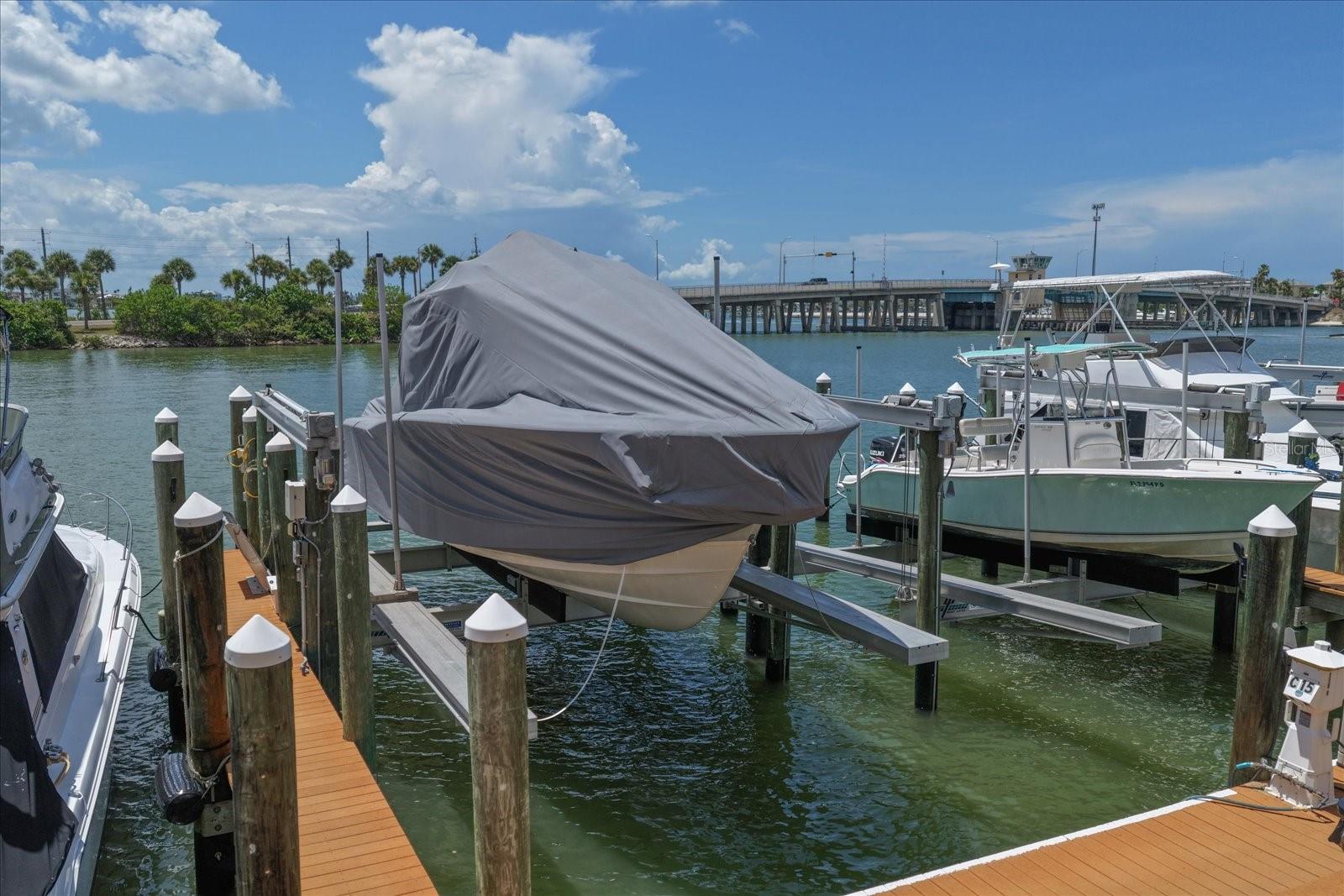 DEEDED DEEP WATER SLIP WITH BOAT LIFT & AUTOMATIC COVER,  A RARE FIND!!  Why settle for a slip alone when you can have your own deeded deep water slip complete with a heavy-duty boat lift and a premium automatic cover system? This slip at Harbor Side Boat Club of Madeira Beach is outfitted with a SunStream piling lift and SwiftShield™ automatic boat cover, accommodating boats up to 40' LOA . With the push of a single button, the hydraulic SwiftShield system pulls a custom-fit, marine-grade WeatherMAX® cover over the sides and stern of your boat,  protecting it from sun fading, salt spray, birds, and debris. No more wrestling with snap-on covers or multiple canvas pieces. Your boat stays cleaner, cooler, and better protected, and you'll be underway in seconds, uncovered and idling out before you've even finished your coffee. Centrally located, you can walk to restaurants, grocery stores, and bait shops as you prep for a day on the water, with easy access to the Gulf of Mexico through Johns Pass. Harborside Marina has 26 boat slips, all deeded and individually owned, with gated access.  Adjacent to the Courtyard Marriott Hotel, an additional monthly fee gets you access to hotel amenities including the fitness center, coin-operated laundry, heated pool and hot tub, and discounts at the bistro and on hotel rooms. Deeded slips are hard to find in Pinellas County — and one with a lift and automatic cover already installed is even harder. Don't wait!