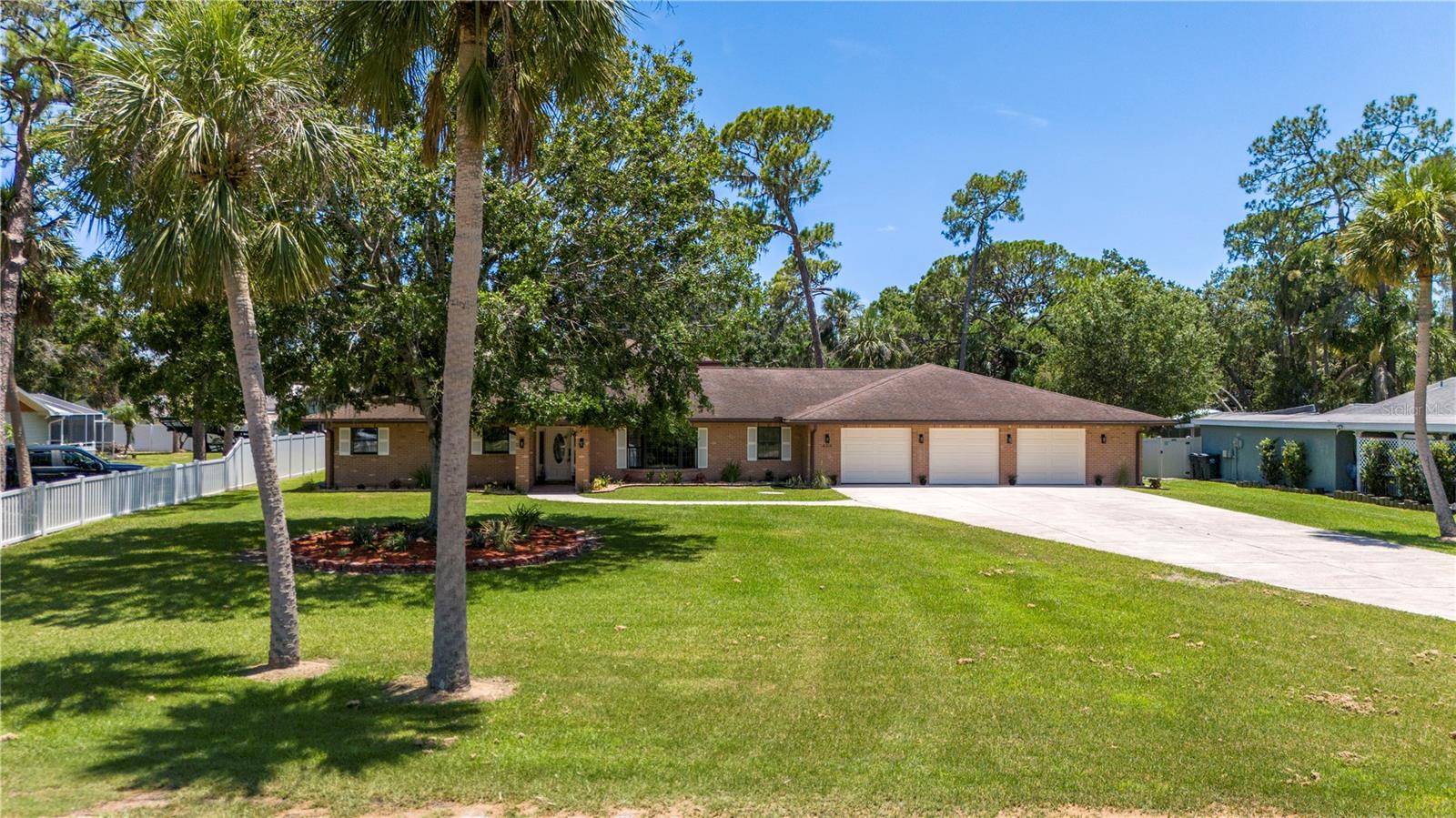 You won't find any other home like this one!    NO HOA OR CDD!   NO BACKYARD NEIGHBOR!
Discover the perfect blend of space, comfort and flexibility in this newly remodeled 4 bedroom, 4 bathroom home in the heart of Ruskin. You will enjoy a relaxing water view at the front of the home and gorgeous sunrises and sunsets from the property. Inside you will find an expansive layout that includes two spacious primary bedrooms, each with its own ensuite bathroom, two large bedrooms, an office, dining room, family room, game area, and a two story great room centered around a Chicago Brick wood burning fireplace (with outside loading wood bins) and an open loft with oak spiral staircase and railing. This room creates an especially cozy and inviting space for gathering. The kitchen features a breakfast nook and bar area for ample seating. There are new LG stainless steel appliances and abundant cabinetry, ready for daily meals and entertaining. A spacious laundry/utility room adjoins the kitchen and the large three car garage. The house opens to the massive covered lanai through french doors in the great room, kitchen/breakfast nook, laundry area, master bedroom and bathroom. This access makes the lanai perfect for parties , outdoor dining, relaxing with your morning coffee or just hanging out in a hammock with a good book!
Throughout the home, fresh updates and a functional layout support a variety of lifestyles or multiple-generational living. The three new air conditioning units allow for convenient temperature control in different areas of the house. Re-piping of all incoming water supply lines with Uponor (PEX) is complete. A new roof will be installed prior to closing, giving the buyer color choice options. Current owners Flood Insurance policy and Termite Protection Policy Warranty are transferrable. Located by the Ruskin Inlet, the home is near the scenic Little Manatee River and Tampa Bay with easy access to boat launches including Common Good Park, E.G. Simmons Park, and Cockroach Bay Aquatic Preserve. The property places you both near nature and convenience to local shopping and dining.
In addition, there is a vacant parcel located directly behind the home available for purchase separately offering a unique opportunity for expansion, storage or investment. (This parcel is not currently listed for sale.). Schedule a showing today and explore all the possibilities this unique Ruskin property has to offer.