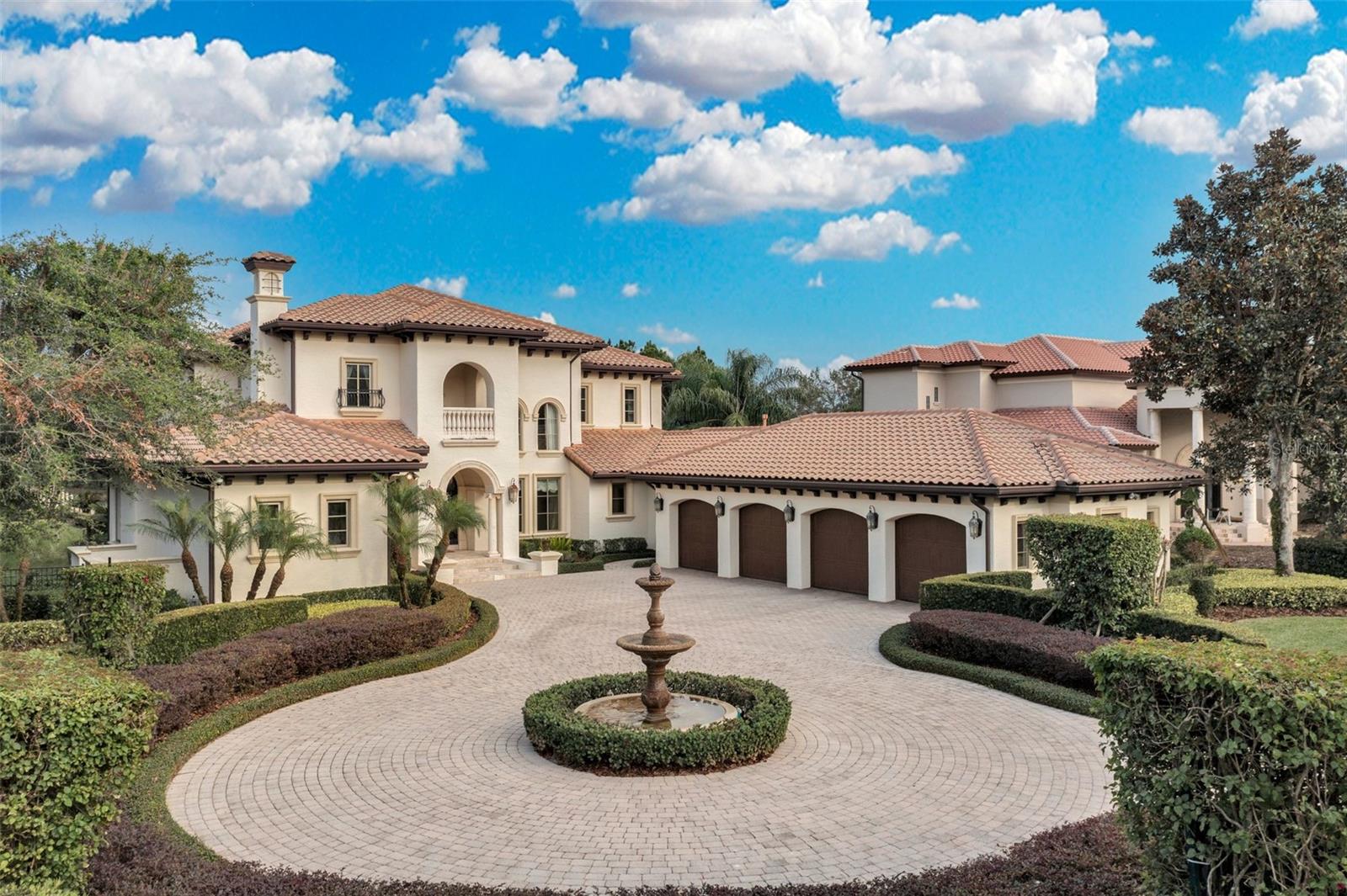 Elegant and timeless, this custom Lakefront Estate built by  Stonebridge Homes presents like a model as it has been a vacation retreat for the current original owners and it looks as new as the day they bought it!   It’s just the right size – not too big and not too small…..5BR/5Full Bath/2Half Baths along with all the essential formal living spaces you would expect PLUS more -- LR, DR, home office, Kitchen-FR combo connecting to a fabulous Game room, wet bar, card room area and a lounge area to watch the big screen -and opening  through 10 ft sliders into an enormous screened pool area with fireplace,  pedestrian bridge over the pool landing onto a deck with lounge chairs to enjoy the firepit!   Stone encased fire place surrounds the dining area with summer kitchen nearby!  Oversized pool and hot tub with all sorts of water features, such as swim up stools at the fireplace – complete this relaxation station for outdoor enthusiasts!    As for the main house, the floor plan is open and inviting, drawing you in with lake views from the moment you step through the front door!  Passing through two sets of custom Cantera iron and glass doors you can see beyond the house, over the pool and boardwalk to Lake Tibet Butler, the second largest lake in the pristine Butler Chain of Lakes.  You will be impressed with the double-sized covered boathouse with separate hoists for a boat and jet skies with drop down covers!   Another amazing bonus is the Keene’s Pointe Nature Preserve along the north side of the property providing the utmost in privacy.   

Primary Retreat and guest ensuite are located on the main floor while 3 Bedrooms and 3 Full baths  are found on the second floor along with a Home Theatre plus a separate gathering room for the upstairs residents with a hospitality bar and balcony to enjoy the  wonderful lake views 

This impeccably maintained estate enjoys a transitional style that when built was ahead of its time.   Attention to detail is impressive; upgrades include top of the line appliances & granite selections, whole house Crestron lighting system integrated with smart home features, central vac, double pane windows and beautiful travertine floors grace the main floor.   Let’s not forget the spotless oversized 4-car garage with built in work bench and epoxy-finished floors.     The boardwalk and dock are also in excellent condition with many extra features.  

Home can be available fully furnished for new owners convenience.   Details to be discussed with sellers.