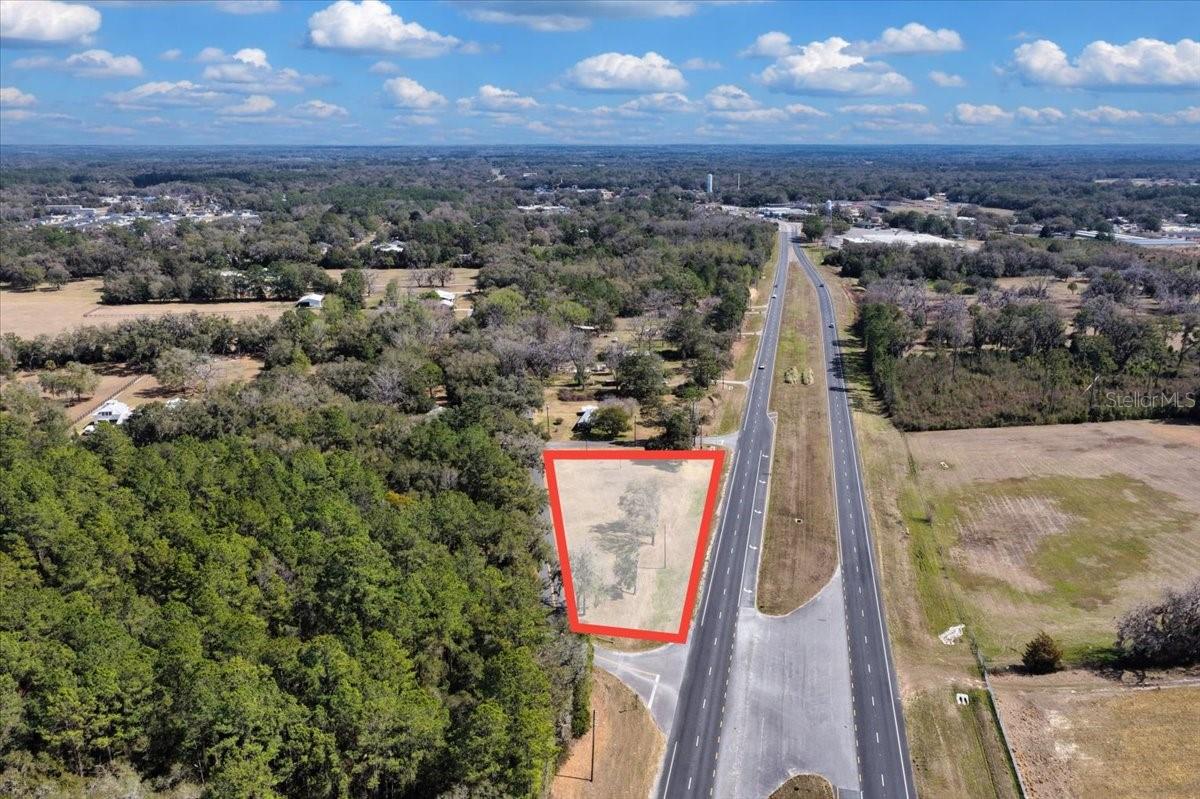 COMMERCIAL 1-ACRE LOT ON ALT US HWY 27 (STATE ROAD 500) – JUST OUTSIDE WILLISTON CITY LIMITS! Excellent opportunity to develop your business in a high-visibility location along Alt US Hwy 27 / Florida State Road 500, a major north–south corridor with strong daily traffic exposure. This 1-acre C-2 Neighborhood Commercial parcel is ideally positioned approximately ¼ mile outside Williston city limits, offering the advantage of lower Levy County taxes while remaining minutes from town amenities. The property features multiple access points, including three adjoining road frontages plus a median crossover on Alt US Hwy 27, allowing convenient access from both northbound and southbound traffic directions. Annual Average Daily Traffic count is approximately 10,500 vehicles, providing outstanding visibility for future commercial use. Zoned C-2 Neighborhood Commercial, intended for businesses serving surrounding community needs (buyer to verify permitted uses with Levy County). Existing power pole nearby; property will require well and septic installation. Conveniently located less than 2 miles from Cedar Lakes Woods & Gardens, Devil’s Den Prehistoric Spring, and Blue Grotto Dive Resort, and approximately 11 miles from HITS Ocala, placing the property near established tourism and equestrian destinations that attract consistent regional and seasonal traffic. Located in Levy County with quick access to Williston, Gainesville, and surrounding North Central Florida markets, this site offers flexibility for investors, entrepreneurs, or owner-users looking to establish a new commercial venture. Bring your vision and build your next opportunity!