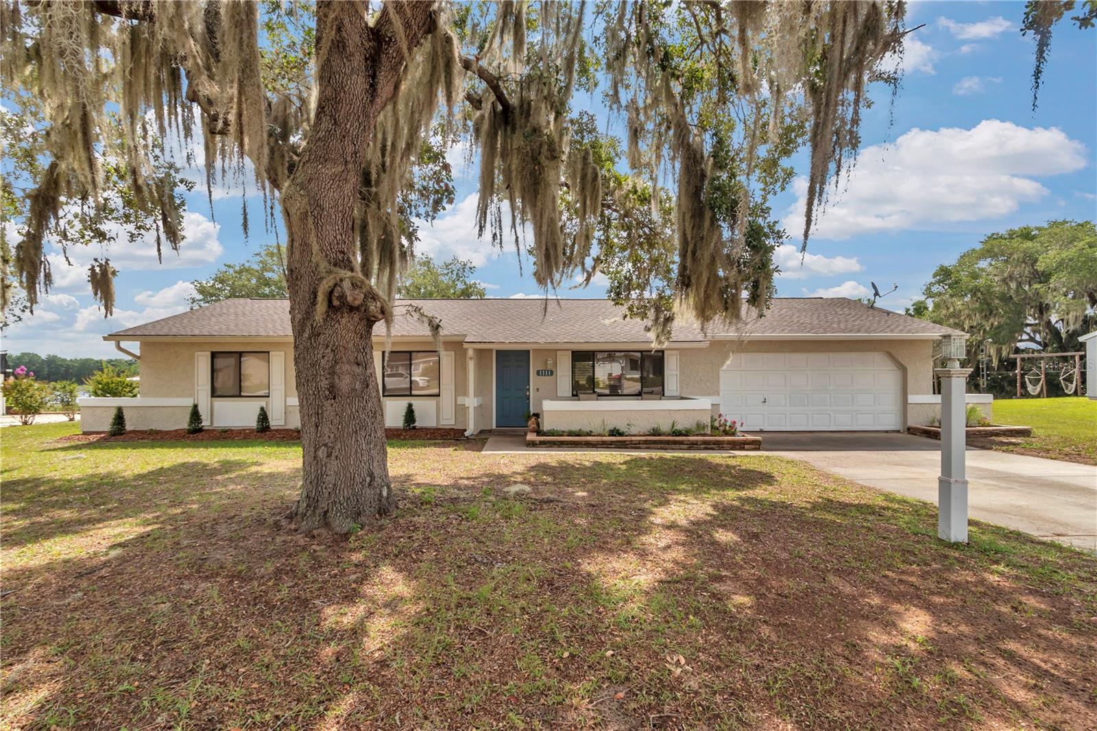 This 3-bedroom, 2-bathroom home sits directly on Lake Joy with expansive water views from the screened lanai. The oversized .43-acre lot offers private lake access on a no-wake, trolling-motor-only lake suited for fishing, kayaking, and paddle-boarding. Inside, 1,316 sq ft of open-concept living includes fresh interior paint, tile and carpet flooring, and abundant natural light throughout. Recent updates include a 2021 roof, 2020 AC system, and 2018 water heater. The backyard is shaded by a mature oak tree and backs directly to the lake. A 2-car attached garage and updated landscaping complete the exterior. HOA is $14/month (Lake Joy/Magic Lake POA), which includes access to the Silver Springs Shores community center and amenities, as well as trash pickup. Located 1.0 mi to Lake Weir High School, 1.1 mi to Emerald Shores Elementary School, 1.2 mi to The Country Club at Silver Springs Shores public golf course, and 1.4 mi to the Silver Springs Shores Community Center with pools, fitness center, and year-round activities. Zoned R-1 single family with county water and sewer service — no well or septic to maintain. Approximately 10 miles to historic Downtown Ocala and minutes to the SR 464/Maricamp Rd corridor, with Publix at Heather Island Shopping Center (2.9 mi) and Walmart Supercenter (3.0 mi) for additional shopping and dining. Includes floor plan and 3D Matterport tour.