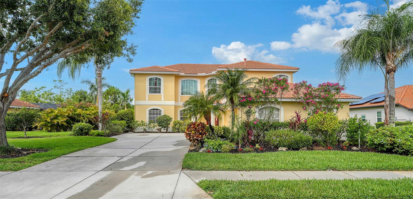 Large Price Reduction. Now's the time. This stately two-story lakefront home seamlessly blends timeless elegance with modern functionality – offering a possible 5-bedroom, 5th used as office. No closet.  4-bath layout that suits every member of the family. A dramatic entryway with soaring ceilings welcomes you in, setting the tone for the spacious design throughout. Formal living room and dining room create a classic atmosphere, while the chef-inspired kitchen is the true showstopper.  Highlights include a large center island with stunning veined slab, rich maple cabinets, and an abundant counterspace.  At the heart of the home is an expansive family room featuring triple sliding doors that lead to a spectacular 50 x 30-foot lanai, a 32-foot lap pool, and a soaring 2 story pool cage – perfect for indoor outdoor living and entertaining. The oversized premium lot offers sweeping lake and preserve views, along with breathtaking sunsets.  Downstairs also features a private office, while upstairs you will find a luxurious primary suite retreat complete with double tray ceilings, a cozy sitting area, a private balcony for morning coffee, and a spa-like bathroom with soaking tub, walk-in shower and dual vanities.  Three additional oversized bedrooms offer generous space and storage.  Additional features include a 3-car garage, newer A/C (2023), new water heater, new pool pump and new water softner.  Located in Grayhawk Landings, a gated 960 acre community surrounded by lakes, woodlands, and over 5 miles of biking and walking trails.  Enjoy access to two resort-style clubhouses, pools with waterslide, spa, tennis, pickleball, basketball, fitness center, playground, and soccer facilities.  All just minutes east of I-75 and close to top rated schools, shopping and dining. This is more than a home – it’s a lifestyle. Schedule your private viewing today!