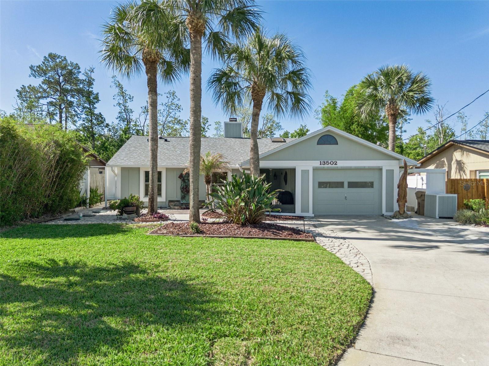 SELLER INCENTIVES BEING OFFERED TO BUYER–DON'T MISS THIS OPPORTUNITY! Experience the best of Florida waterfront living in the highly desirable Lake Harris Shores community! This beautifully updated 3-bedroom, 2-bath home offers 1,505 sq. ft. of inviting living space with DIRECT CANAL FRONTAGE, providing effortless access to the renowned HARRIS CHAIN OF LAKES. Spend your days cruising, fishing, or exploring the waterways with your private 10x24 boathouse and 14x60 Trex dock with lift! Inside, warmth and charm welcome you with a bright, open floor plan designed for comfortable living and easy entertaining. Gather in the spacious living room featuring a cozy wood-burning fireplace, host memorable dinners in the formal dining room, or enjoy preparing meals in the beautifully updated kitchen complete with soft-close cabinetry, solid surface countertops, and stainless steel appliances including a gas range. The generous primary suite is a peaceful retreat with French doors opening to the screened patio, where tranquil water views await. The en suite bath has been given a modern update with a large walk-in shower. Two additional bedrooms provide flexibility for guests, family, or a home office, with one bedroom featuring a Murphy bed and custom shelving that conveys. Engineered hardwood and tile flooring throughout offer both style and easy maintenance. Step outside to your private backyard oasis featuring scenic conservation views and no rear neighbors for added privacy. Enjoy peace of mind with extensive recent upgrades including a new roof (2025), Goodman AC/heat pump (2023), gas water heater (2023), septic field and sump pump replacement (2021), new irrigation pump and system (2021), plus dock and lift replaced in 2021. HOA fee includes drinking water, and irrigation is supplied from the canal. Perfectly located just minutes from the Turnpike and charming downtown Mount Dora, everything Clermont has to offer, Tavares, Leesburg and only 30 minutes to Orlando - this exceptional home offers the ideal blend of comfort, convenience, and lakefront lifestyle you've been dreaming of. *Aerial photo property lines are an estimate and to be verified by buyer.